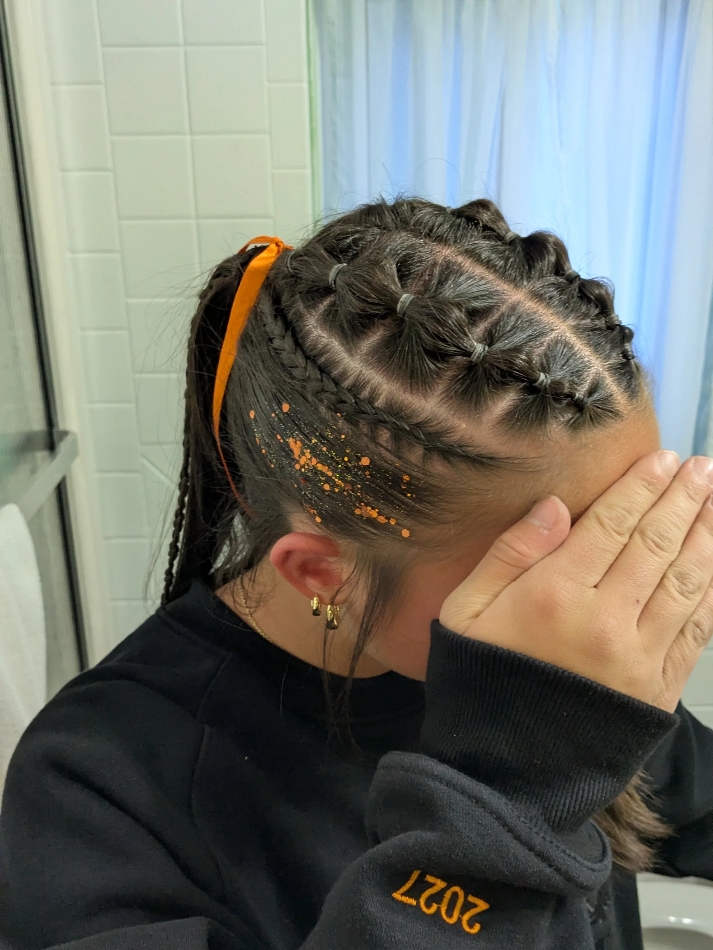 Elastic row braids leading into a high athletic ponytail