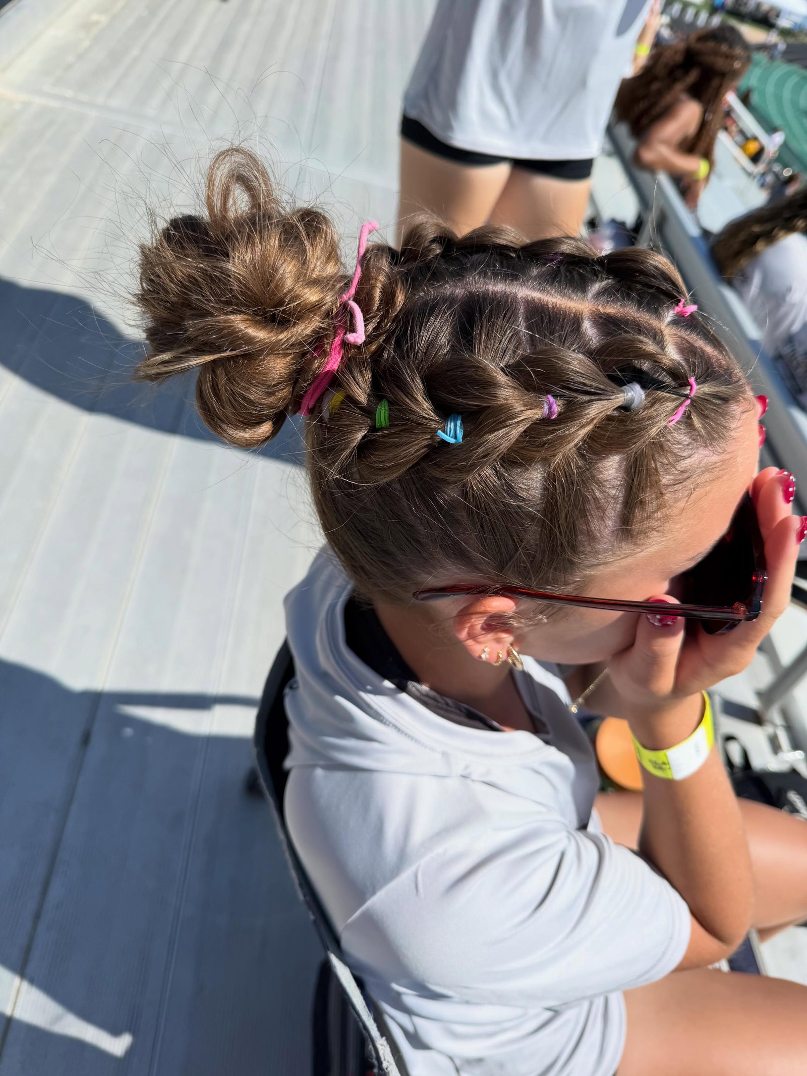 Colour pop athletic braids with small elastics and a messy bun