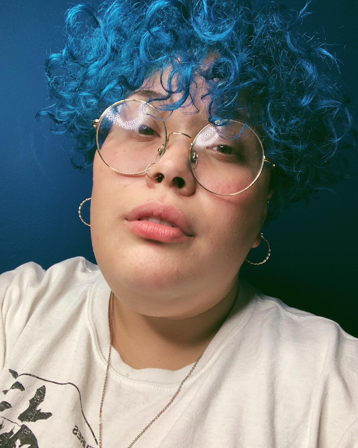 Short blue curly crop with tight curls and closely cut sides
