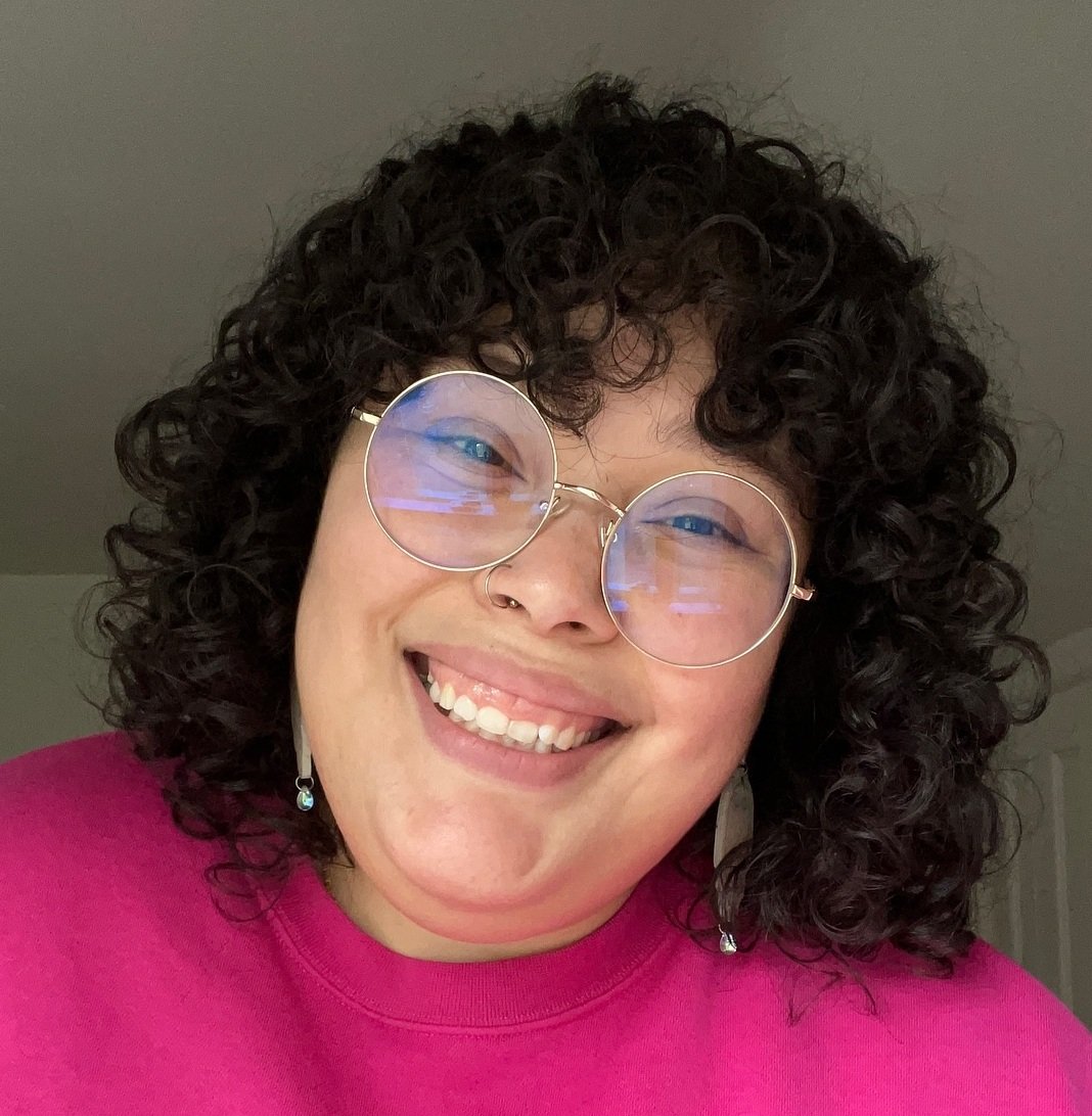 Rounded shoulder-length curly shag with a soft curly fringe