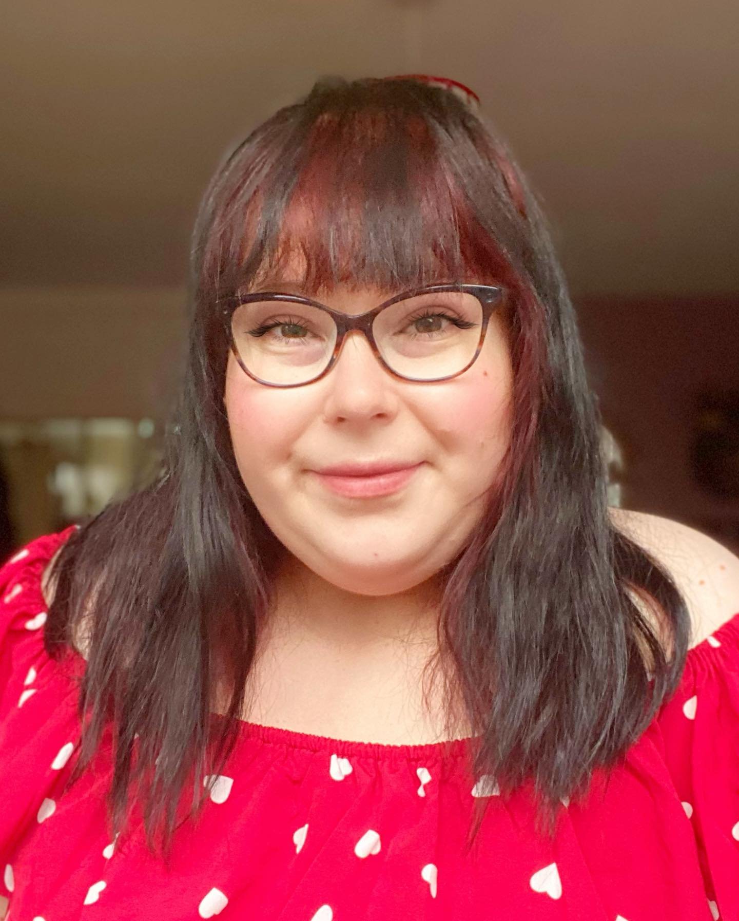 Straight shoulder-length haircut with soft wispy bangs