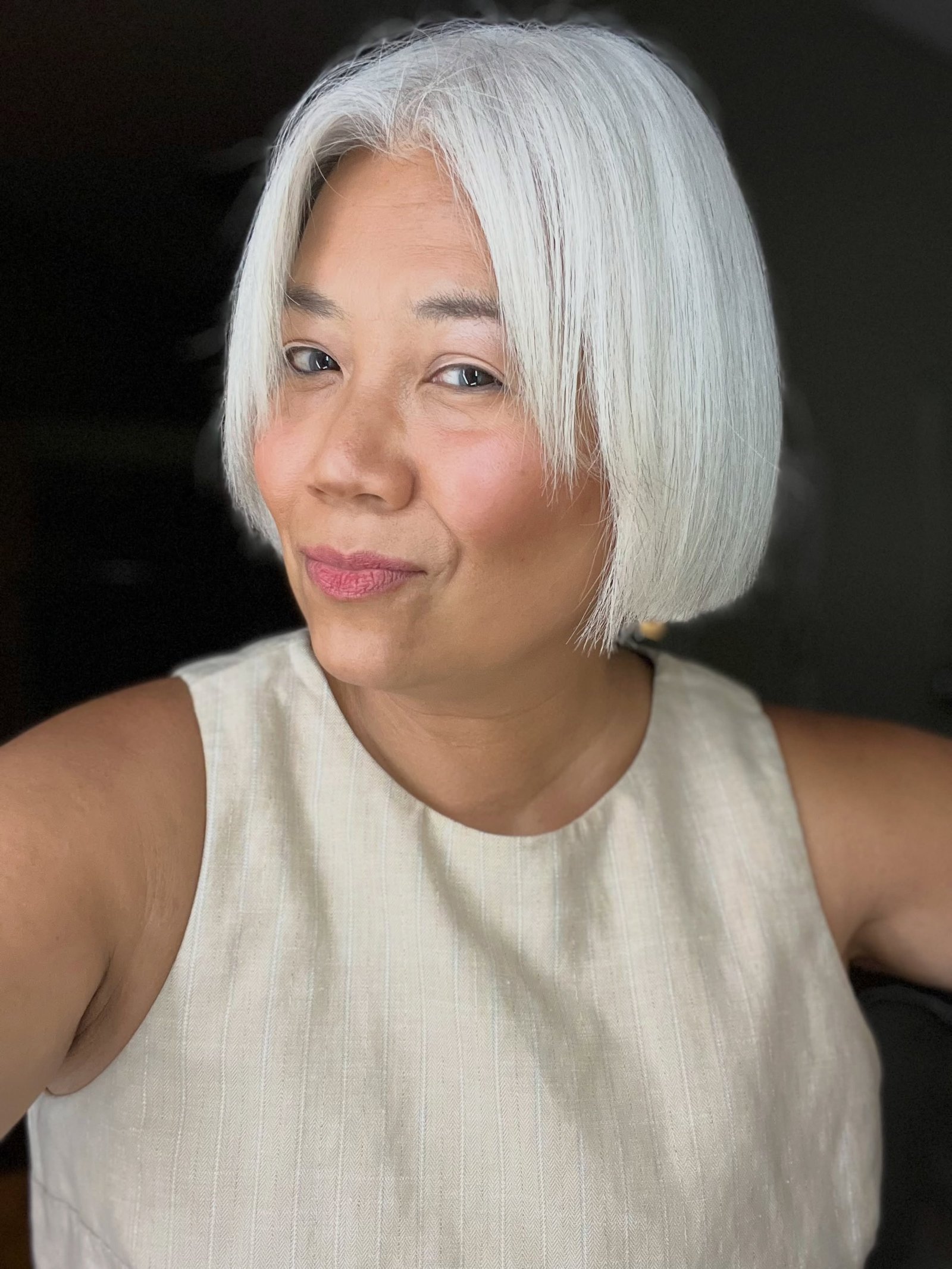 Centre-parted blunt silver bob with a smooth chin-length shape