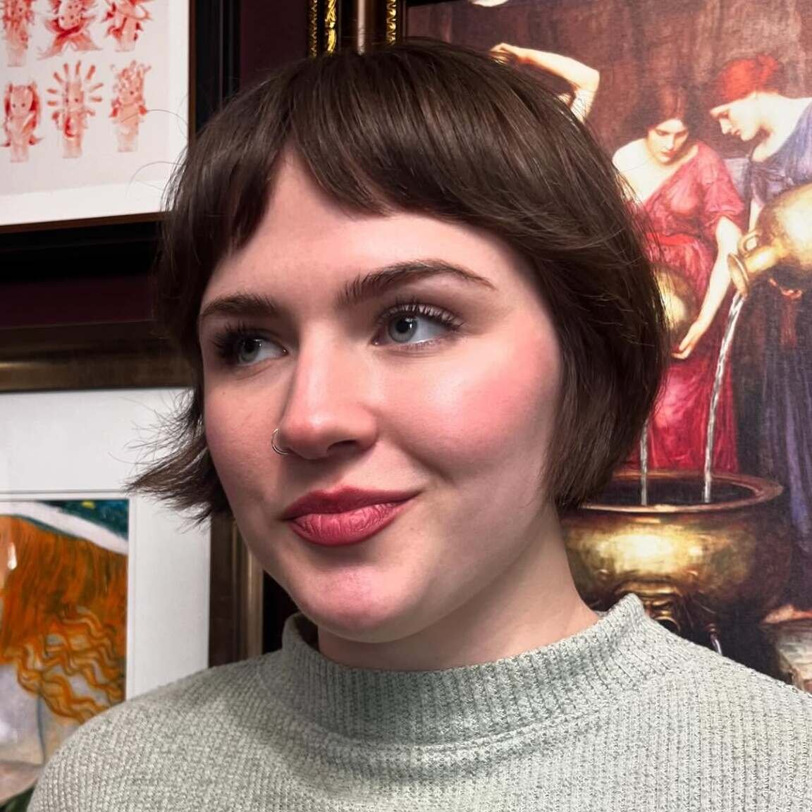 Rounded dark bixie haircut with wispy fringe and softly flipped ends