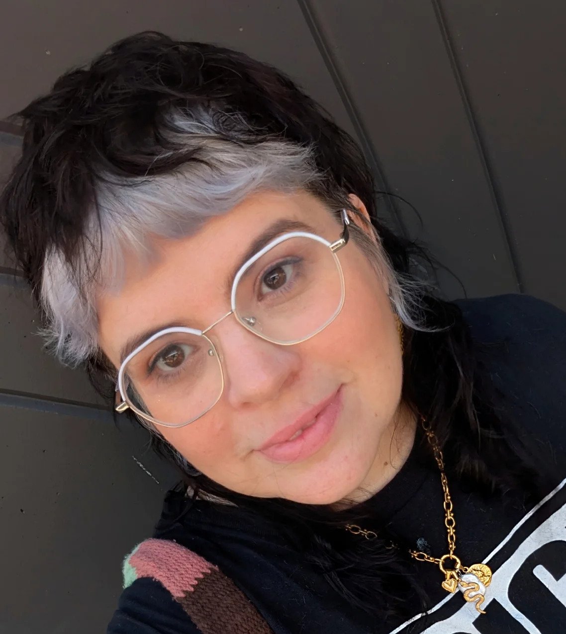 Short wavy pixie with silver face-framing streaks and dark sides