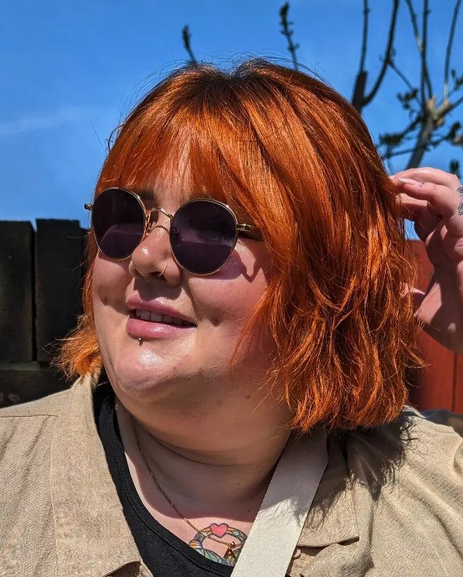 Tousled copper bob with full fringe and softly flicked ends