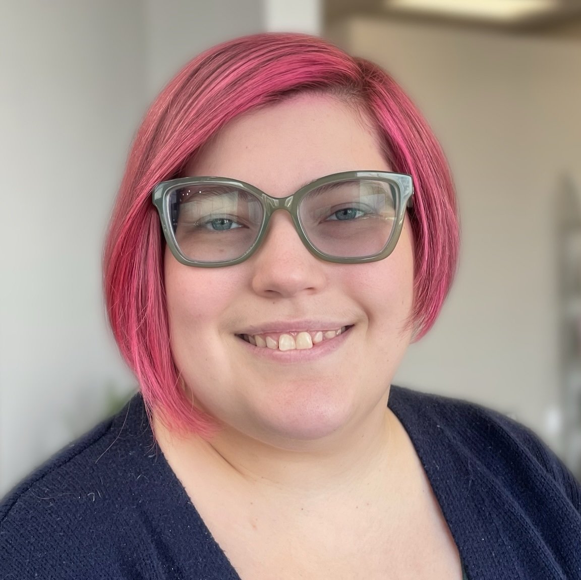 Bright pink side-parted bob with chin-length face-framing pieces