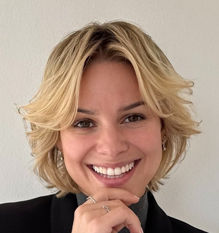 Blonde feathered pixie bob with a centre-parted curtain fringe