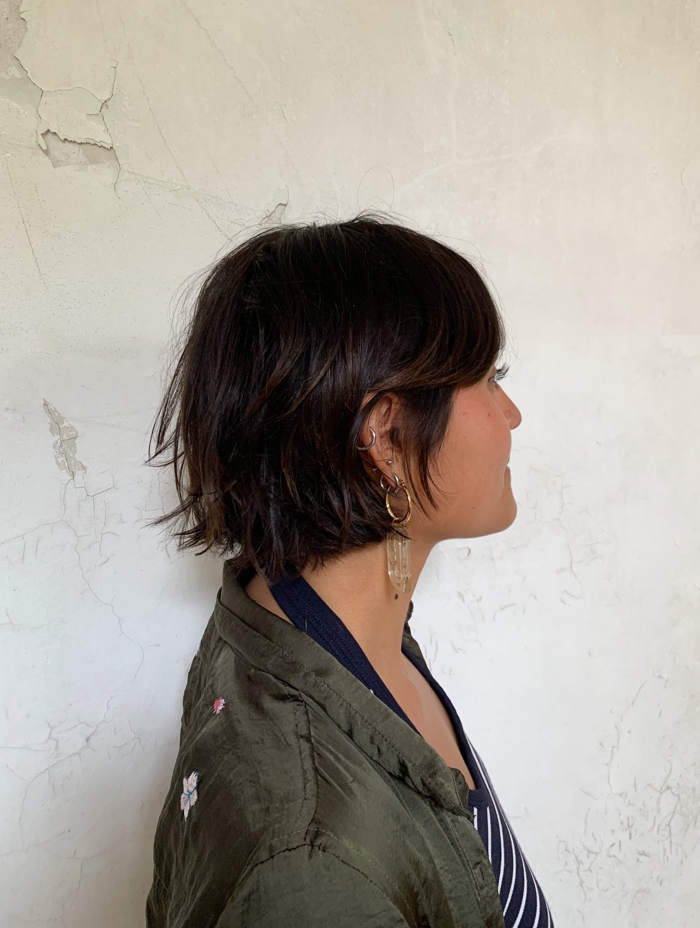 Dark shaggy pixie bob with a full fringe and flicked nape layers