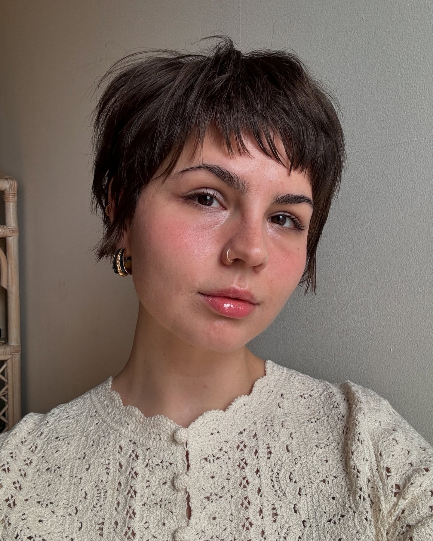 Dark choppy pixie haircut with a piecey short fringe