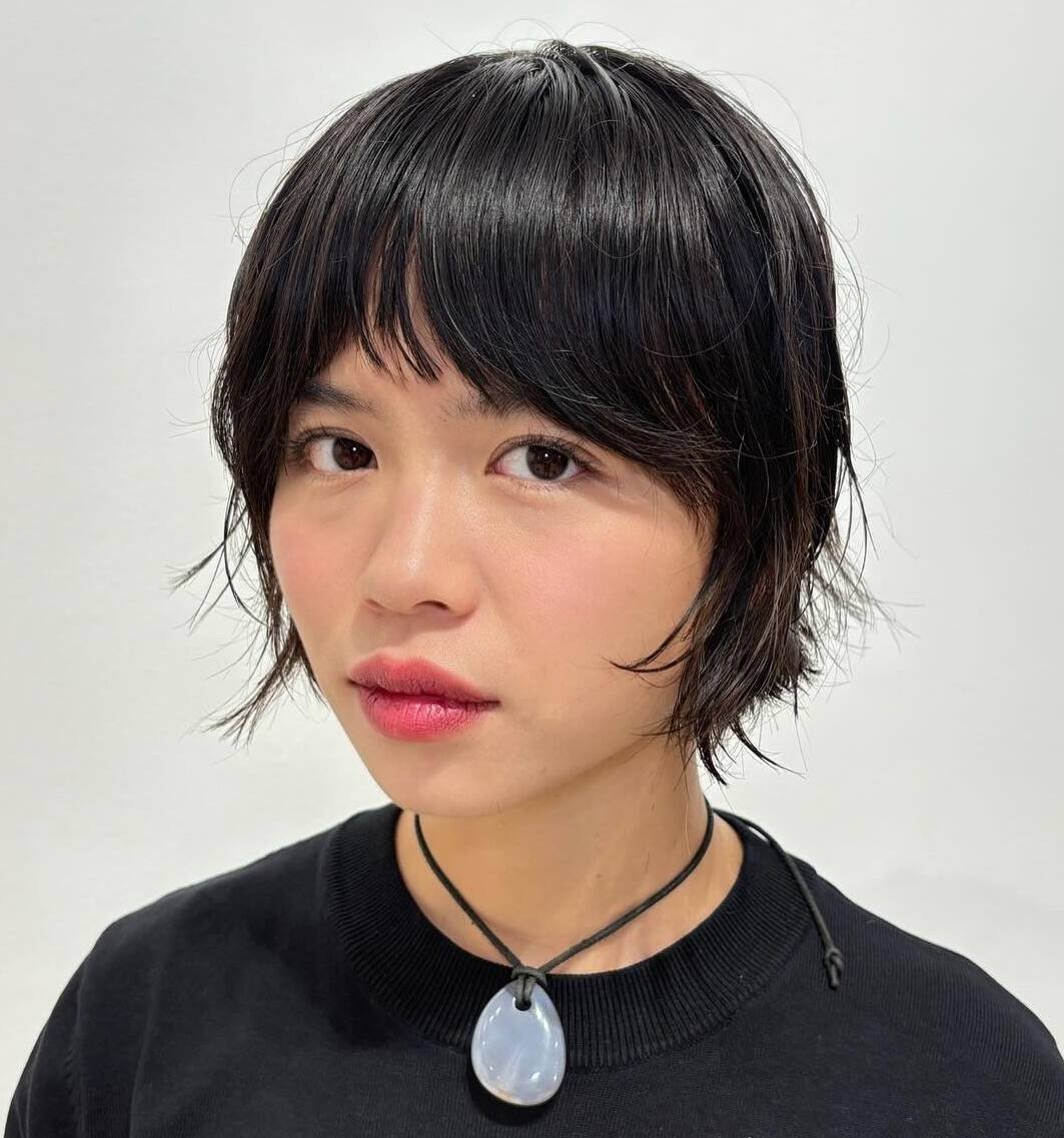 Black textured pixie bob with soft fringe and wispy ends