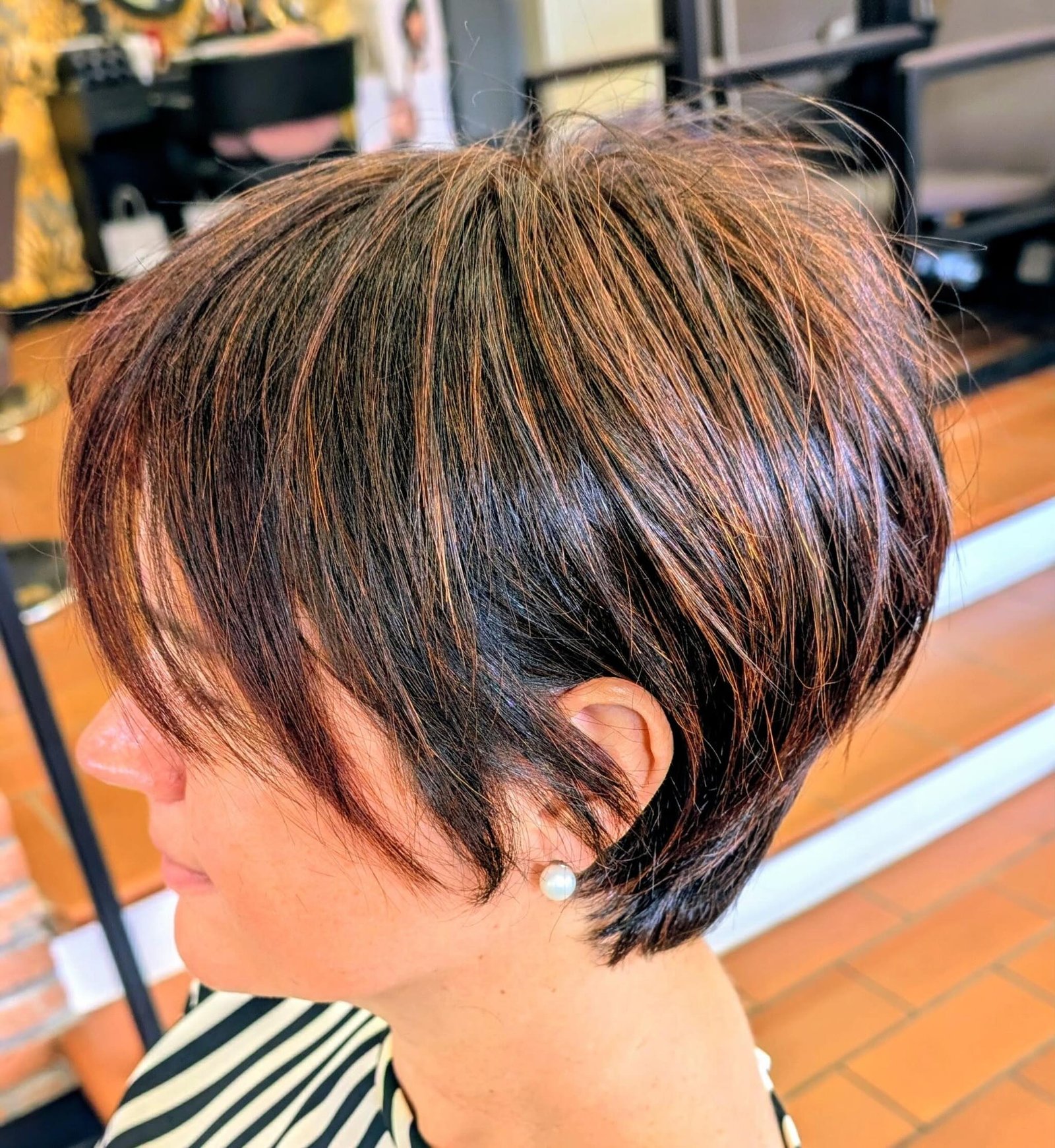 Highlighted stacked pixie bob with a long side fringe and tapered nape