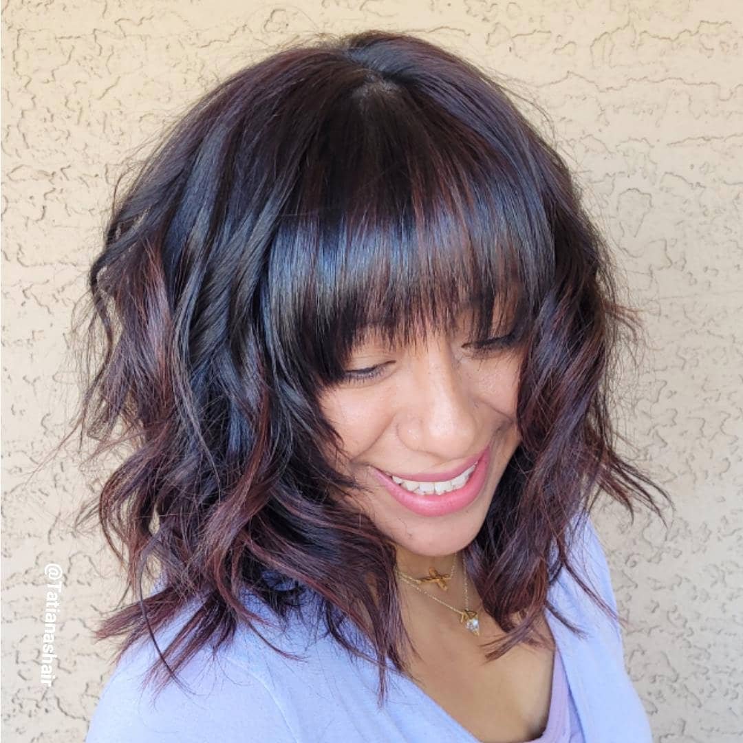 Shoulder-length wavy shag with full fringe