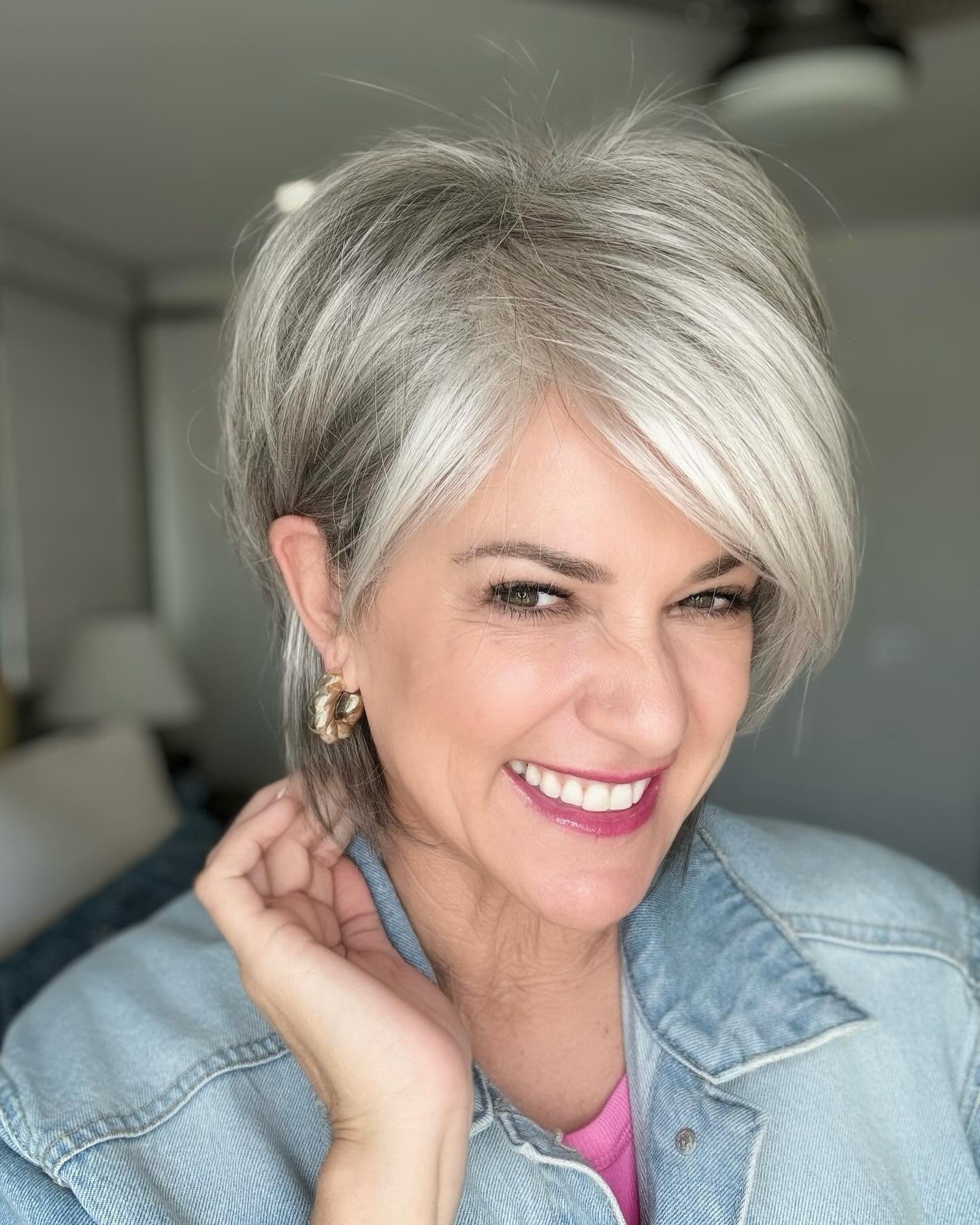 Silver pixie haircut with a long side-swept fringe