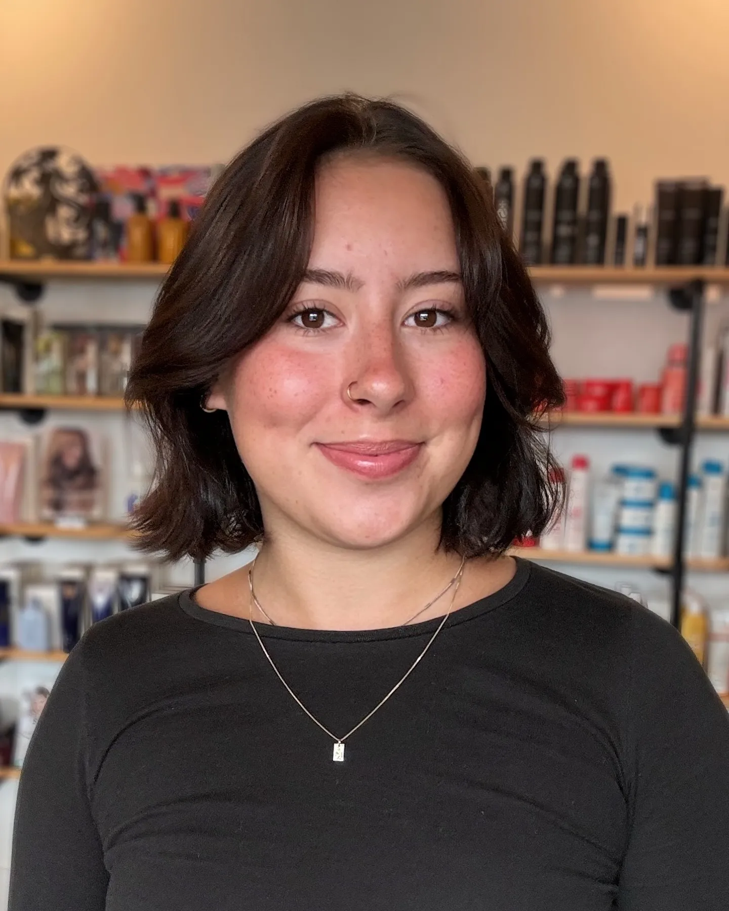 layered brunette bob with curtain bangs and flipped ends