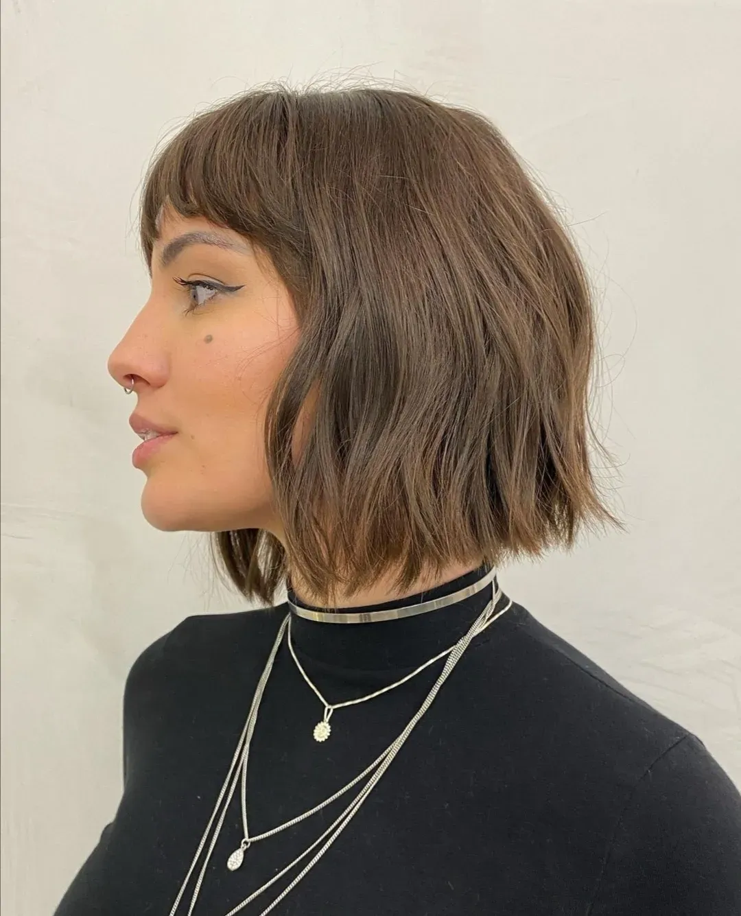textured jaw-length bob with baby bangs and piecey ends