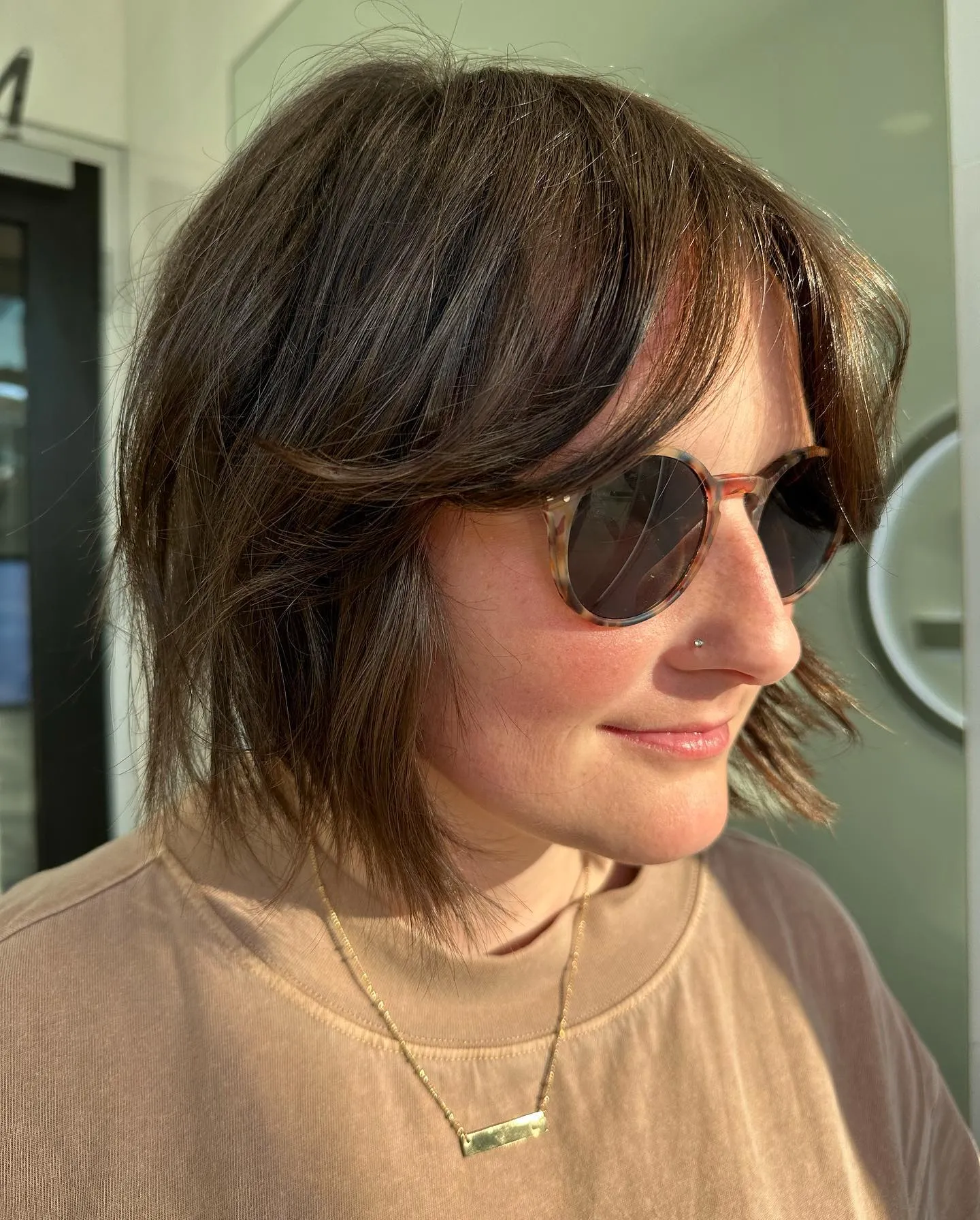 shaggy brown bob with long curtain fringe and feathered side layers