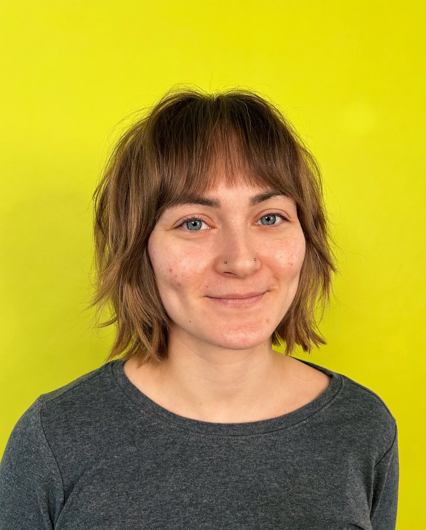 choppy brown bob with short full fringe and piecey ends