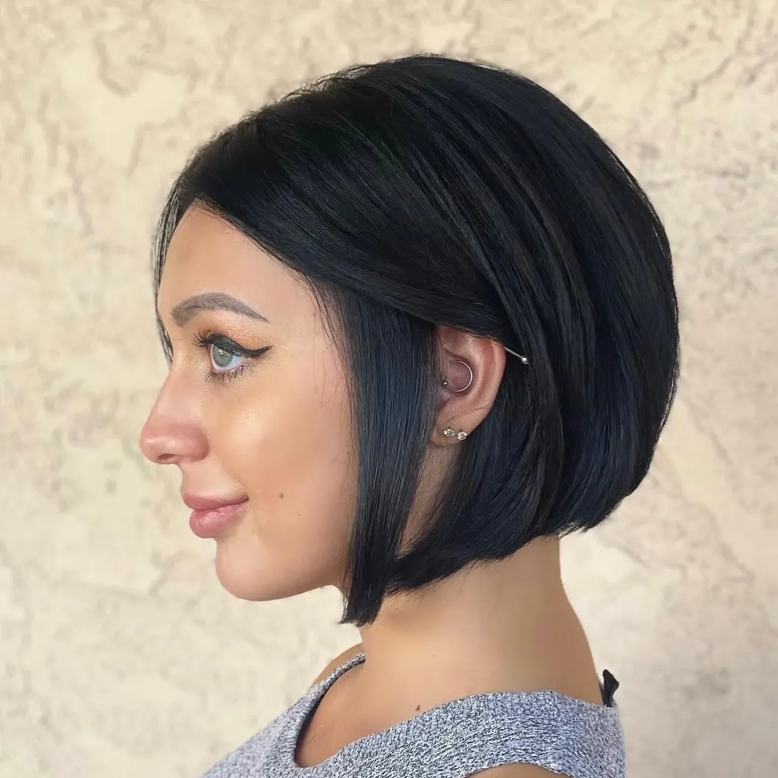 sleek black rounded bob with side part and longer front sections