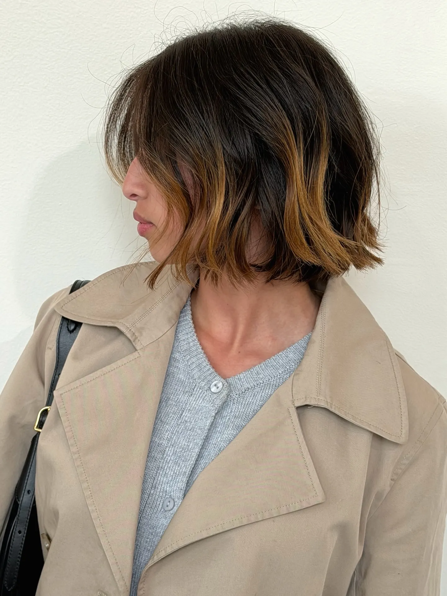blunt dark bob with warm face-framing panels and centre part