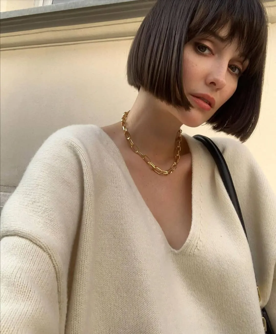 sleek dark French bob with full fringe and sharp jaw-length line