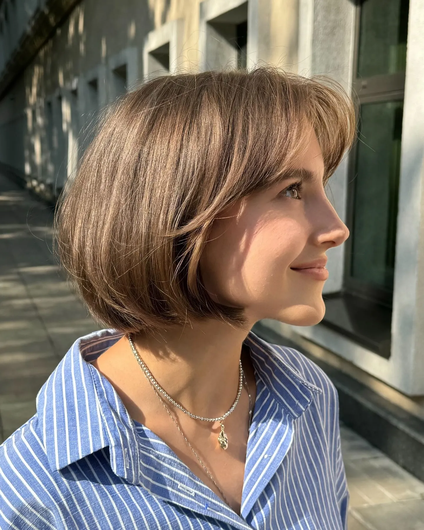 rounded chin-length bob with sweeping front layers and smooth curved ends