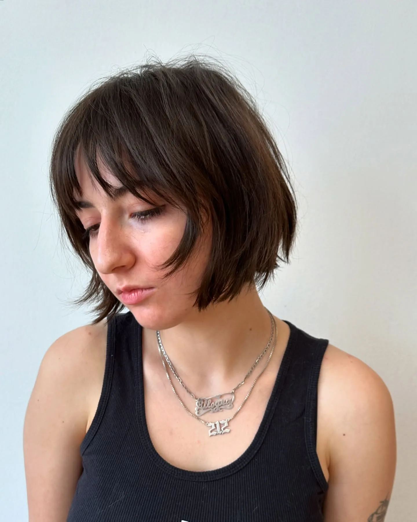 choppy dark bob with soft curtain fringe and separated ends
