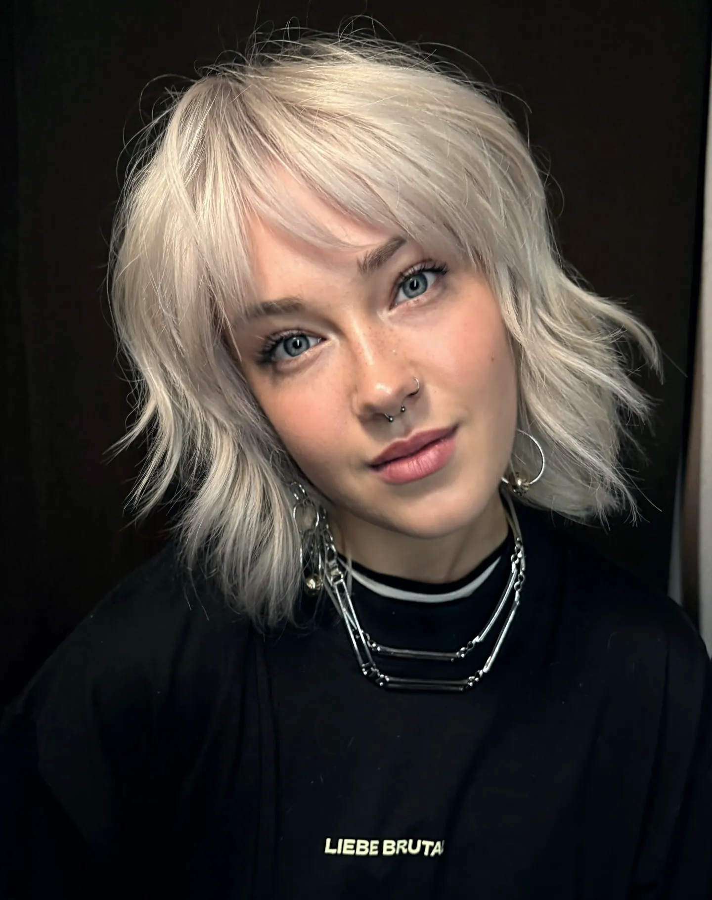 shaggy light bob with wispy curtain bangs and flicked layers