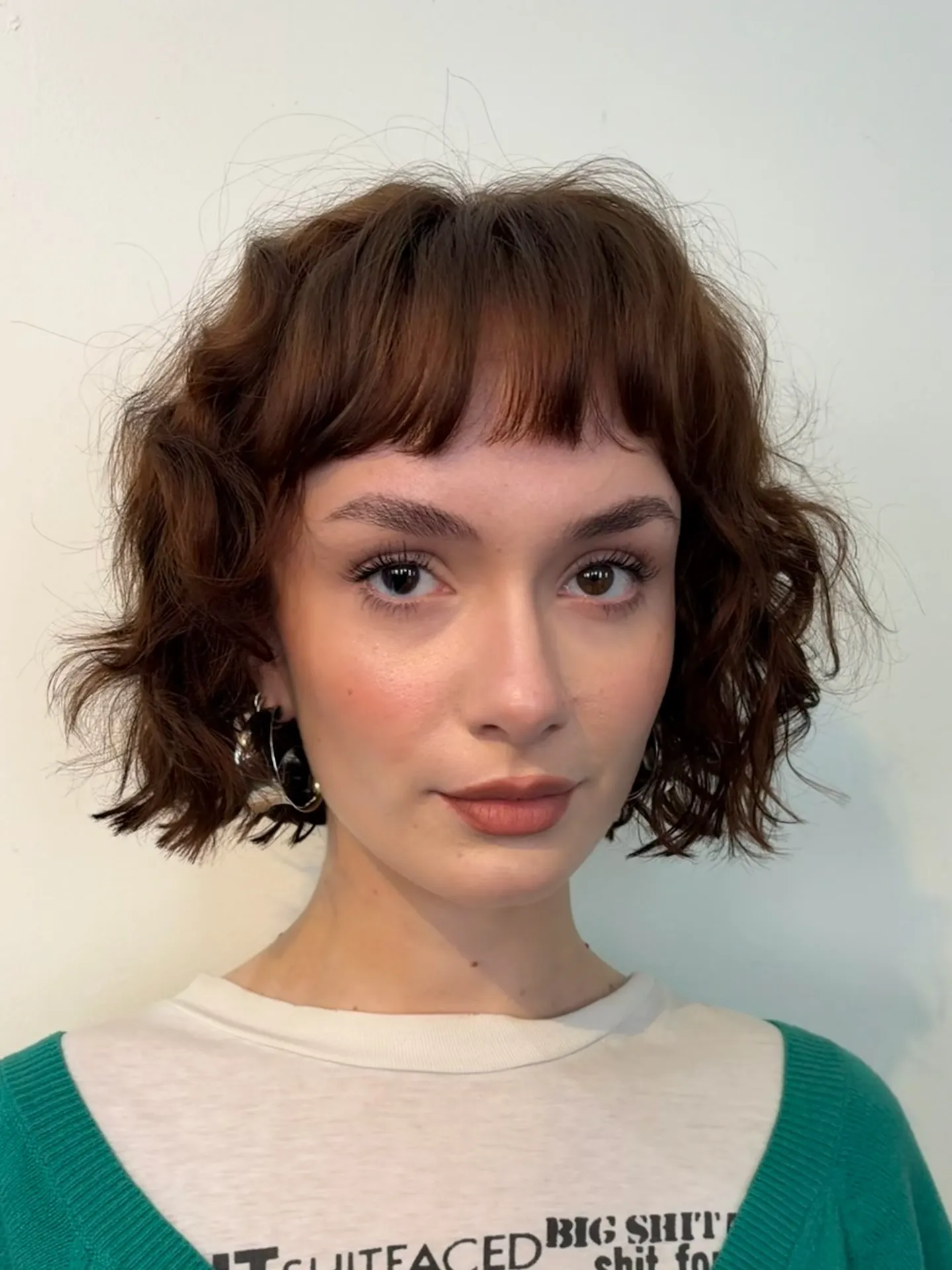 curly chin-length bob with short blunt fringe and defined ringlets
