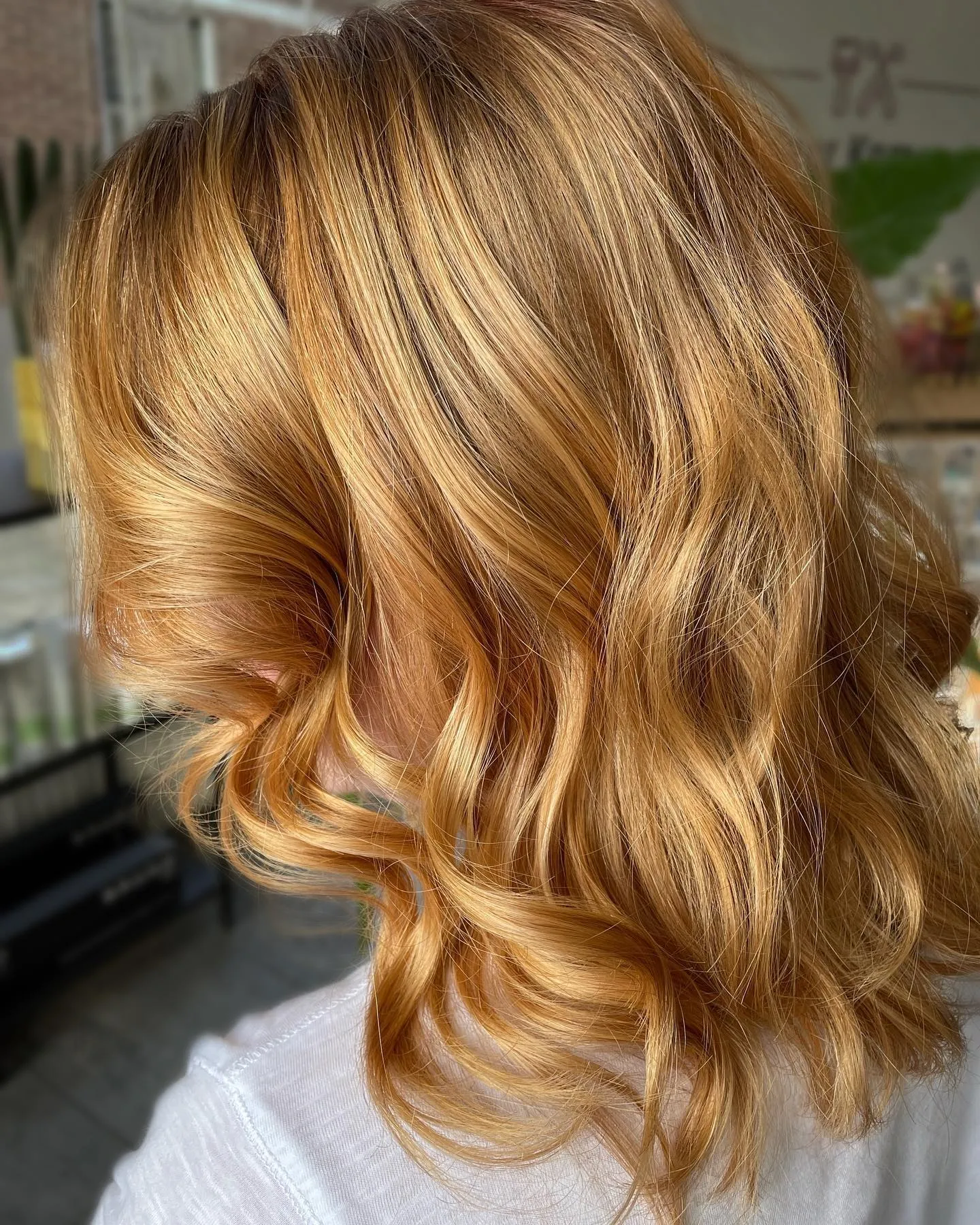 Golden amber shoulder-length waves with soft curls