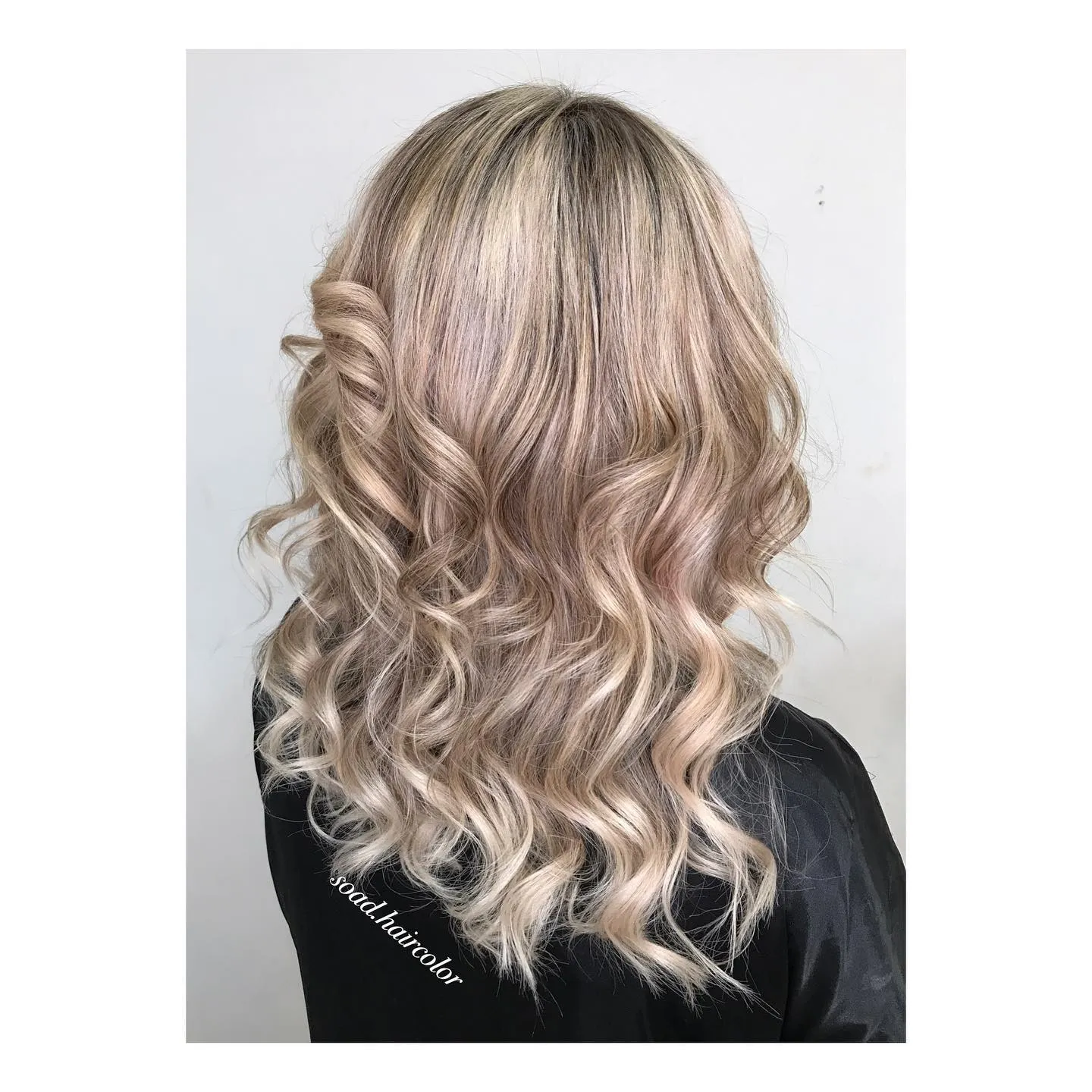 Pale neutral blonde hair with soft curls and side twist