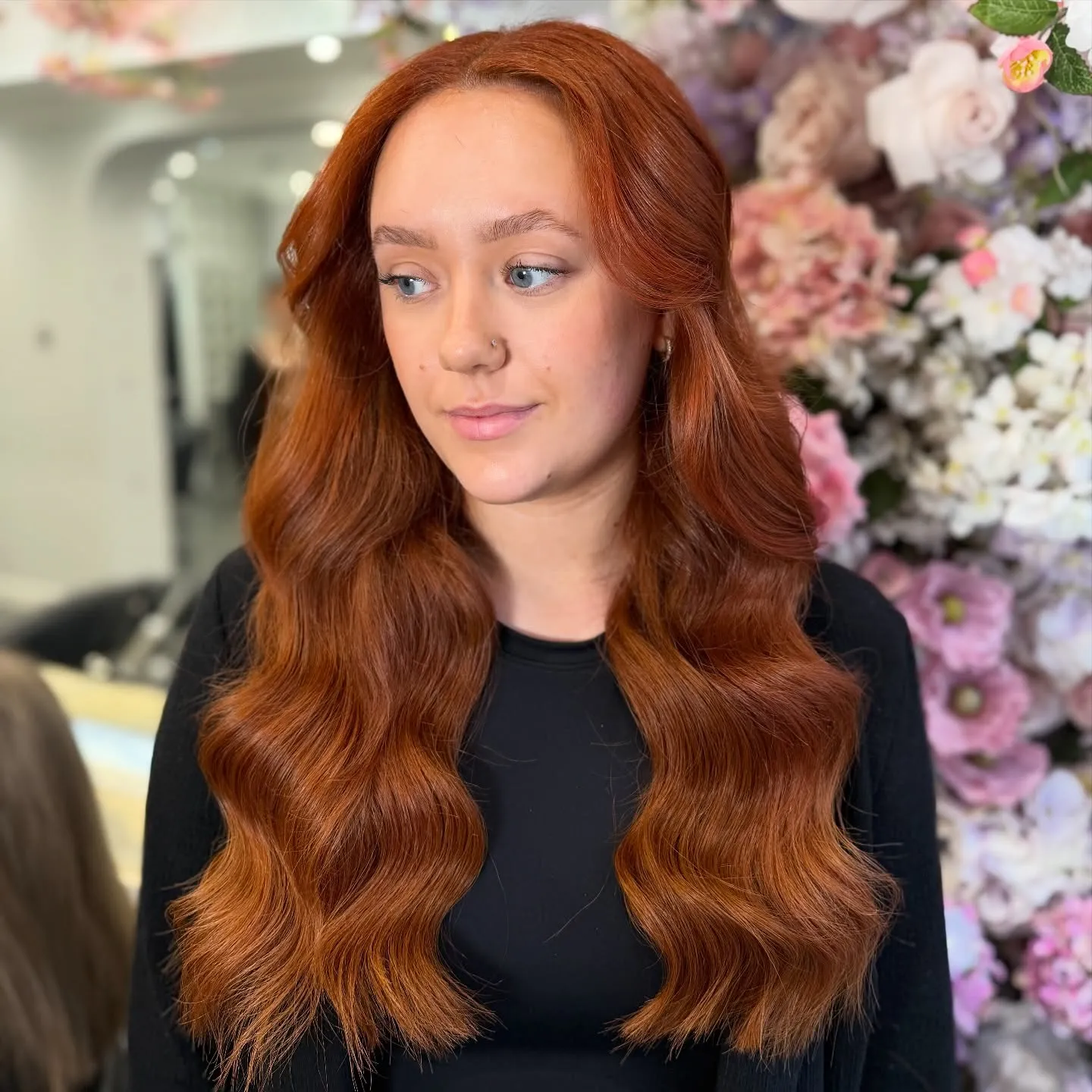 Long deep copper hair styled in smooth waves
