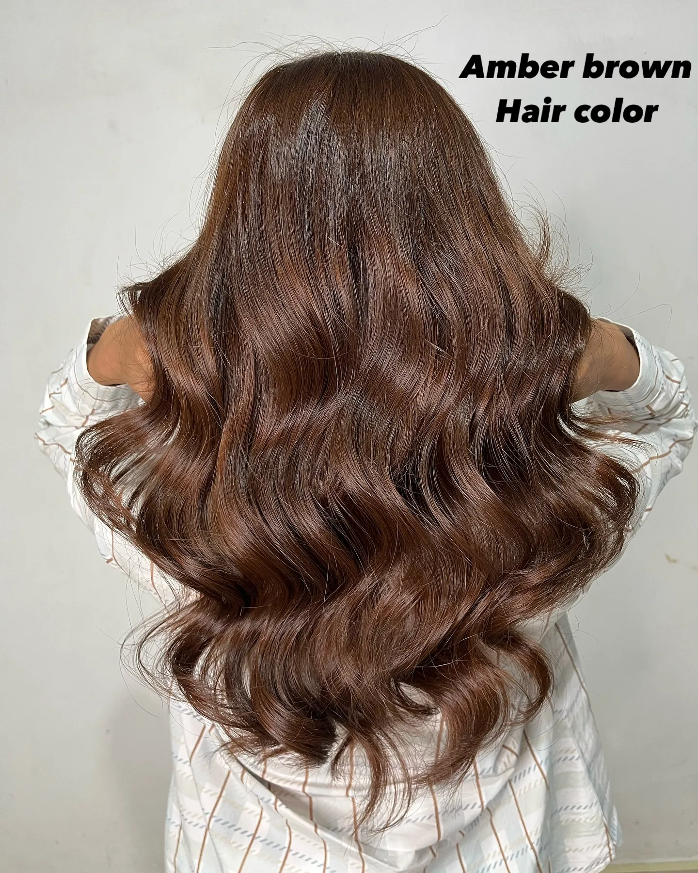 Long amber brown hair styled in loose waves