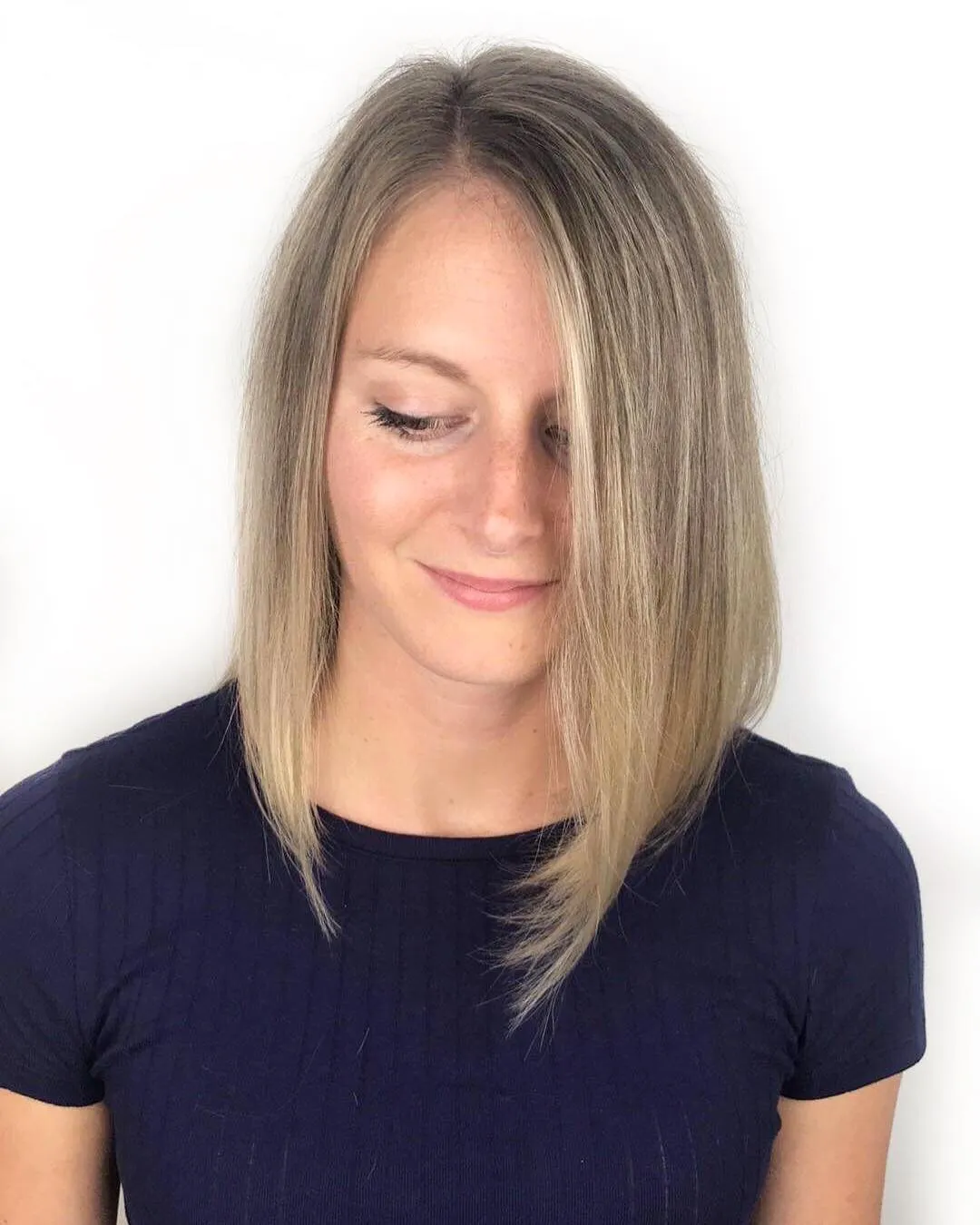Side-part blonde angled lob with long front layers