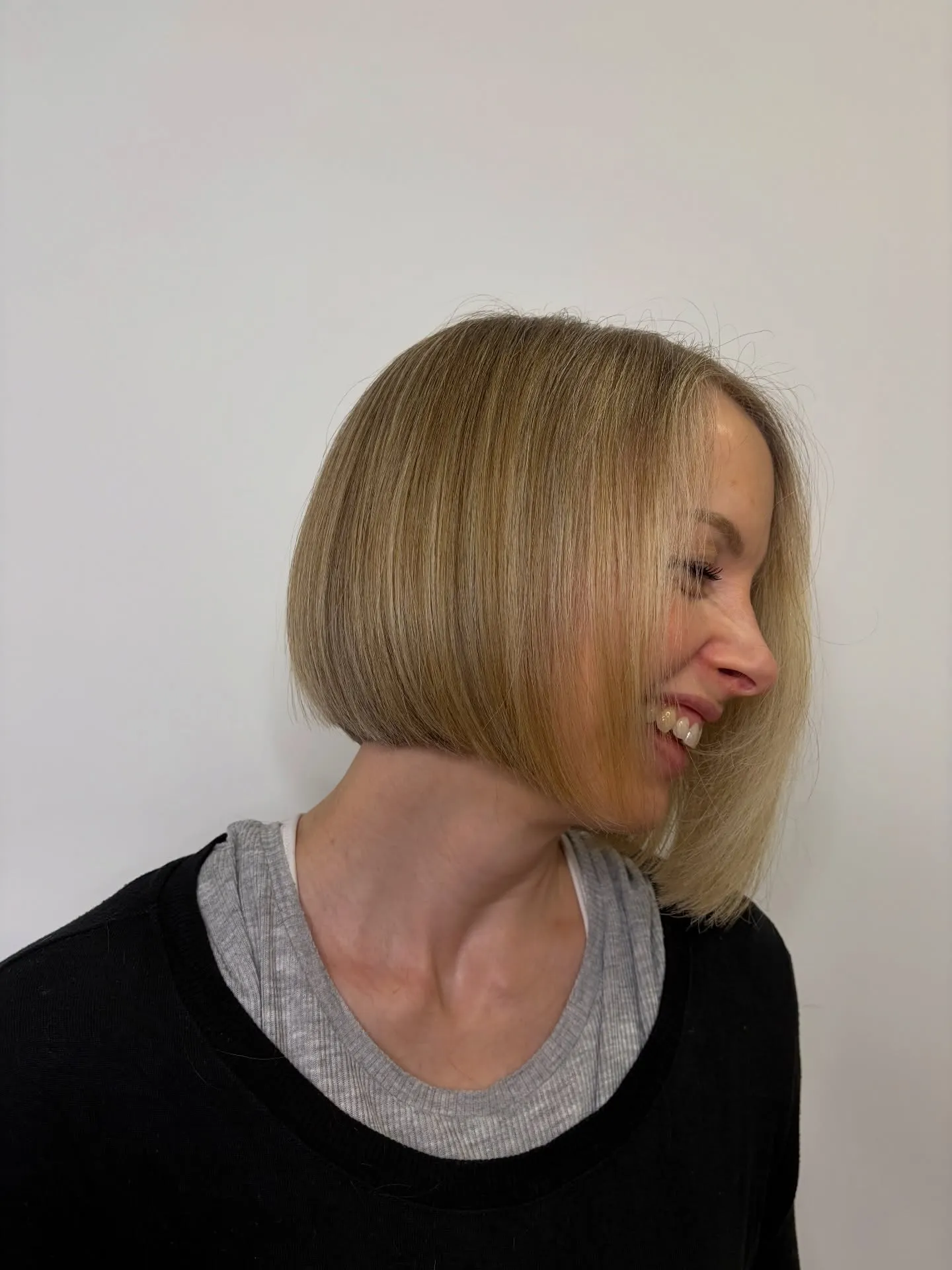 Soft blonde angled bob with a long face-framing front