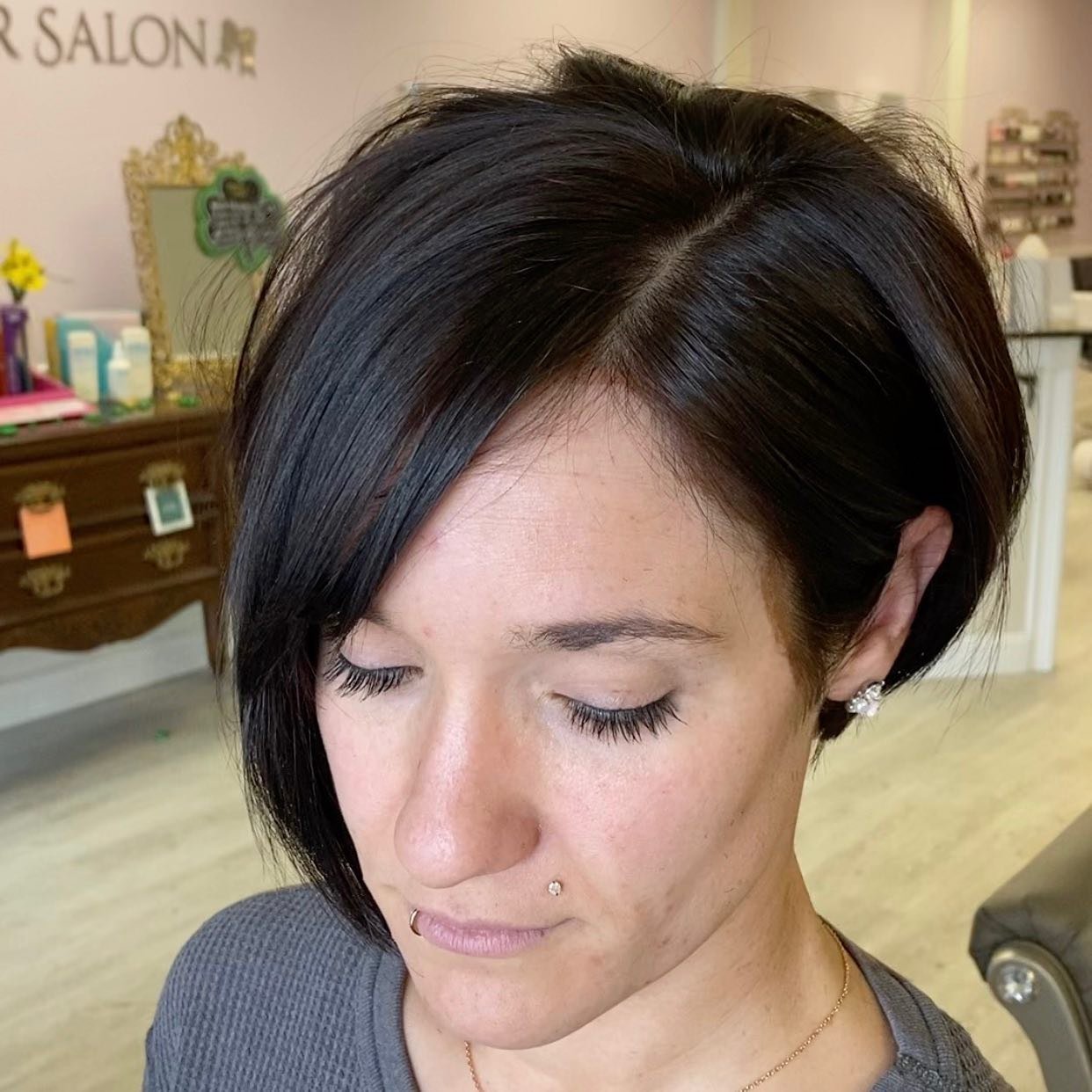Glossy dark asymmetrical bixie with a stacked crown
