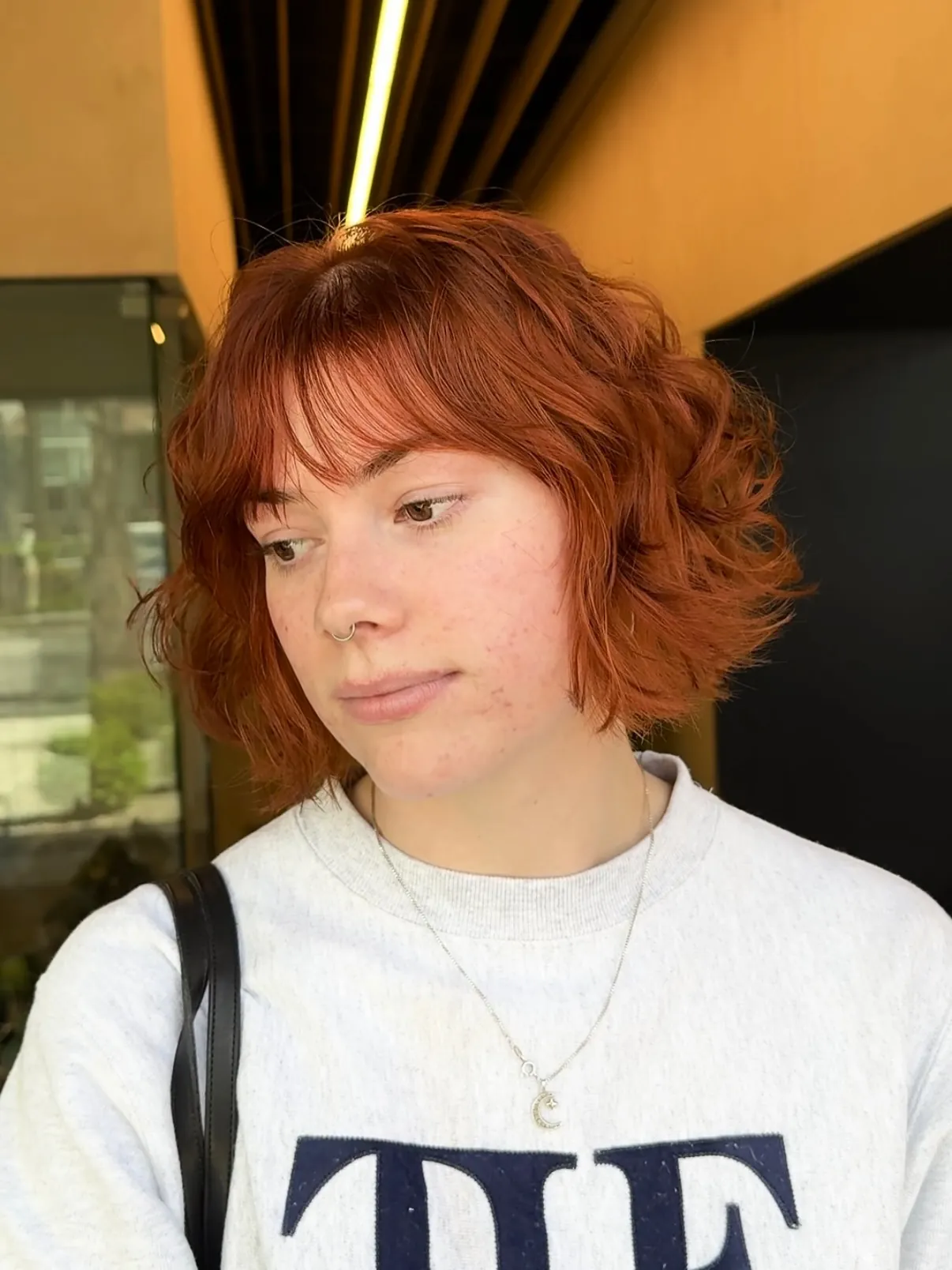Short copper bob with side-swept fringe