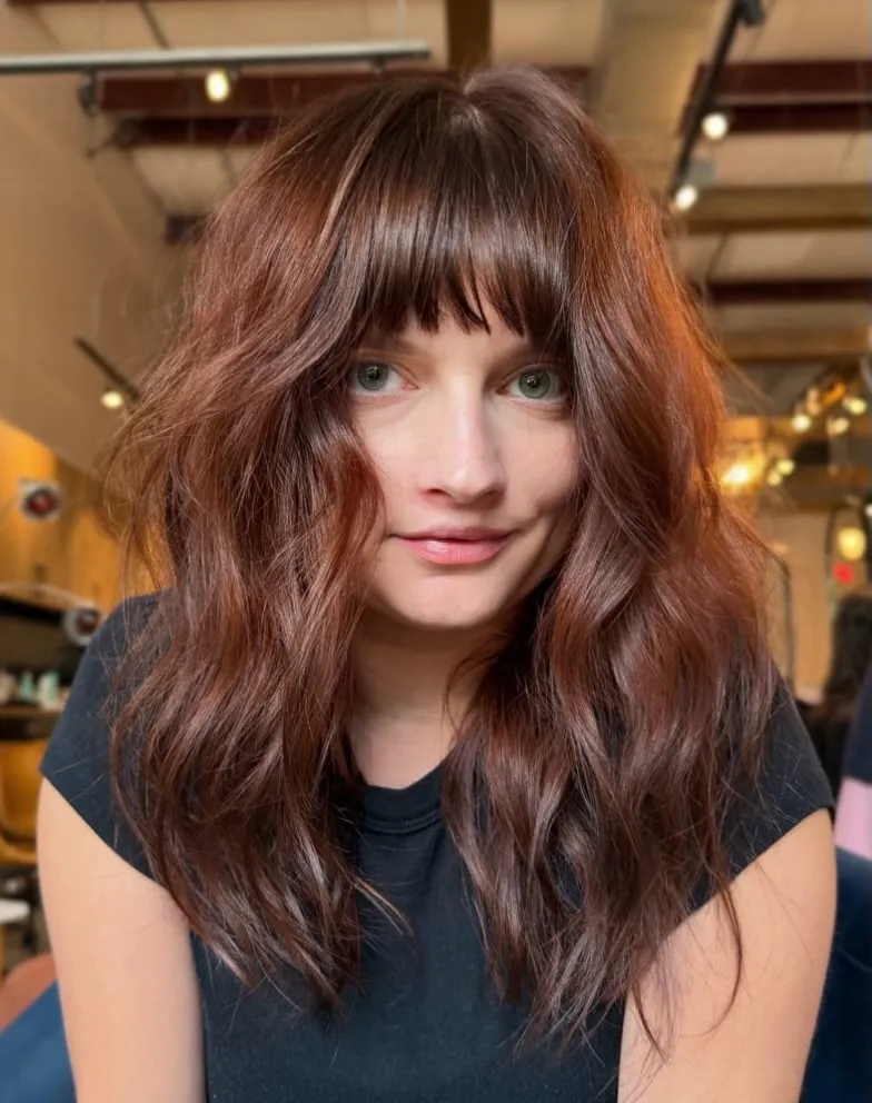 Wavy brunette hair with rounded full bangs