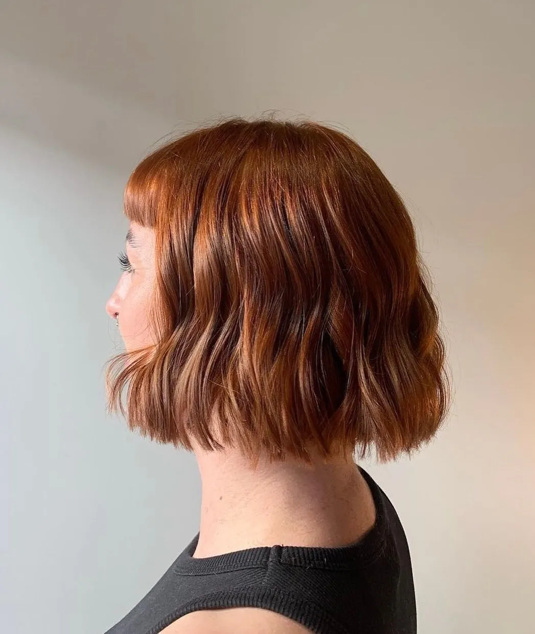 Copper blunt bob with loose side-profile waves