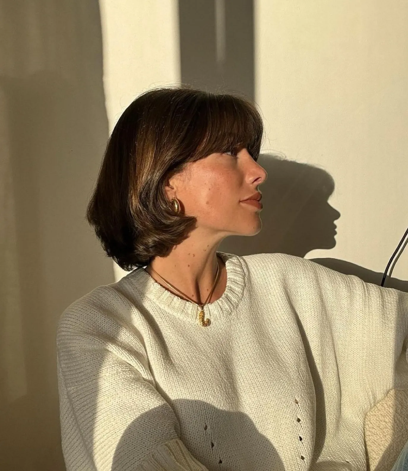 Dark curved-under bob with full fringe
