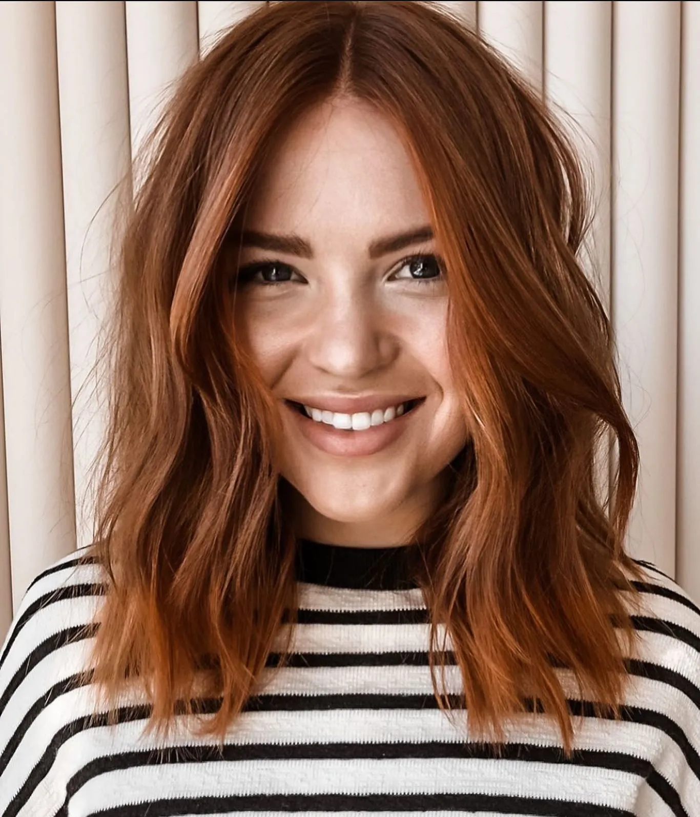 Auburn long bob with center-parted loose waves