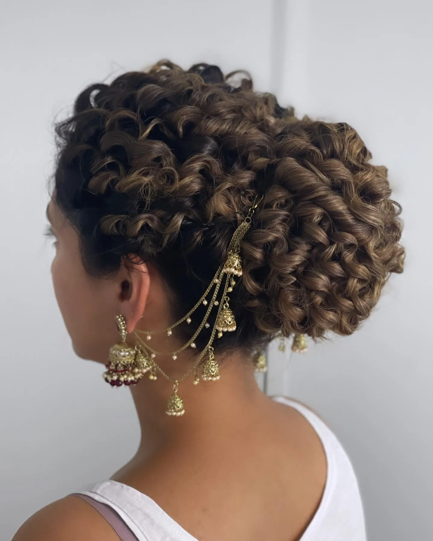 Pinned curly bun with defined loops