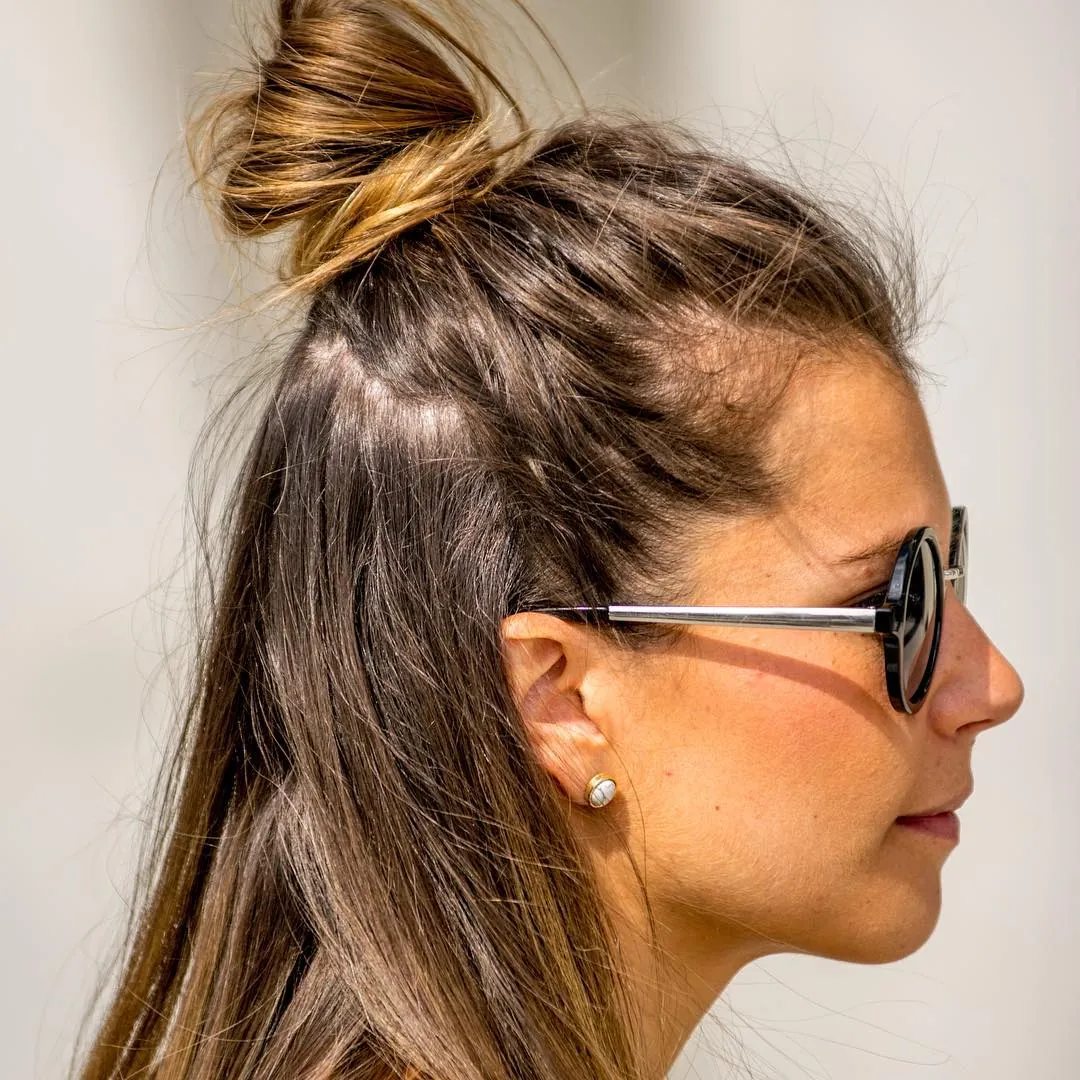Half-up mini bun with long straight hair