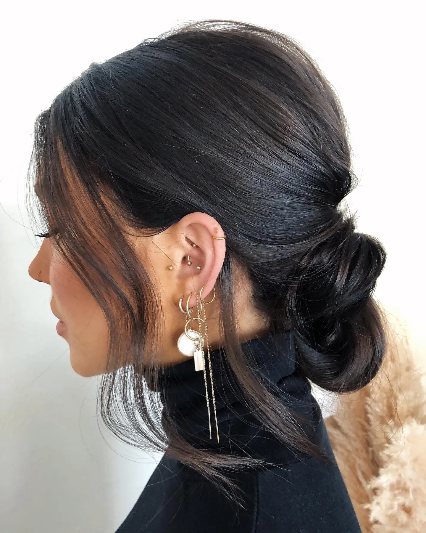 Sleek low bun with loose face-framing strands