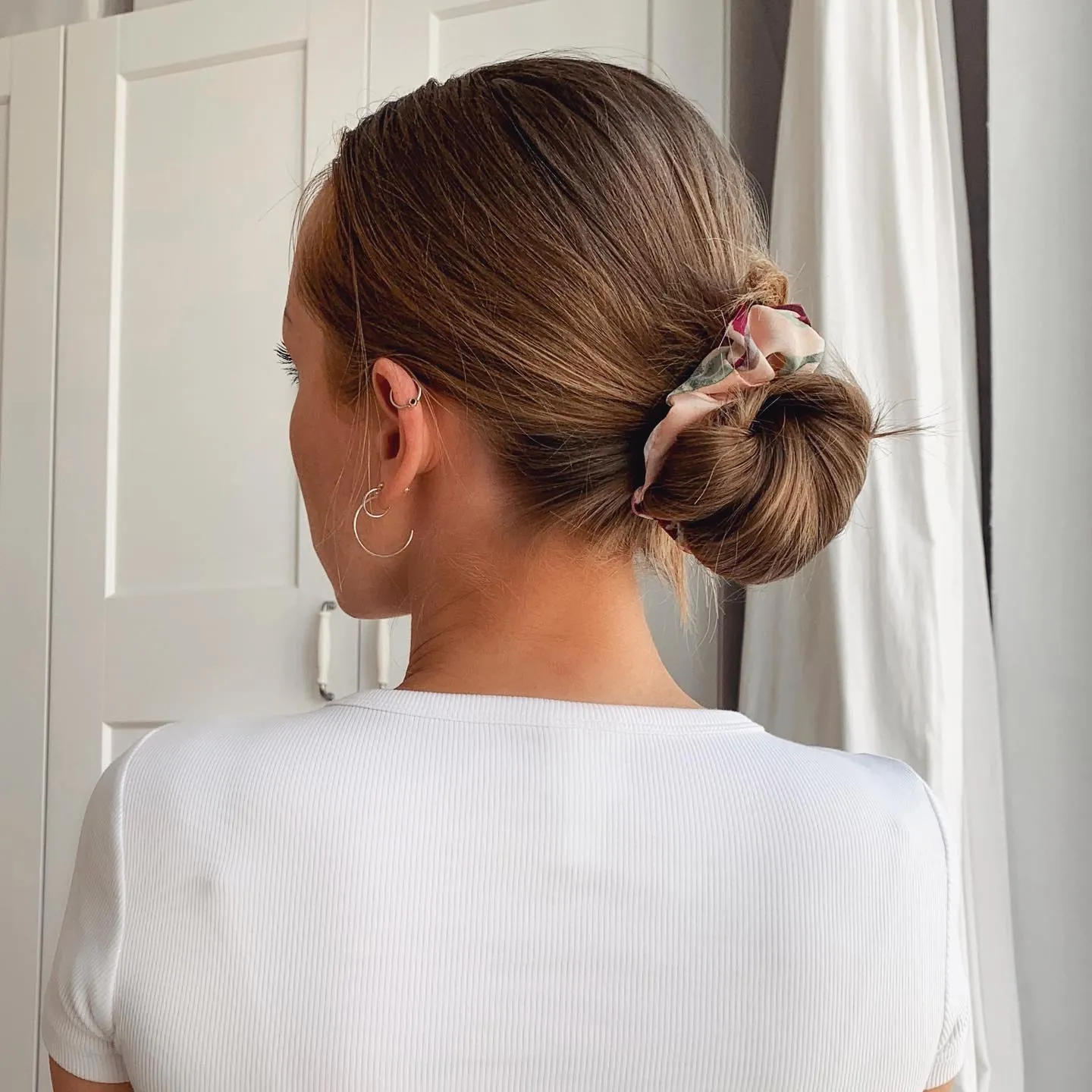 Low bun wrapped with a patterned fabric tie