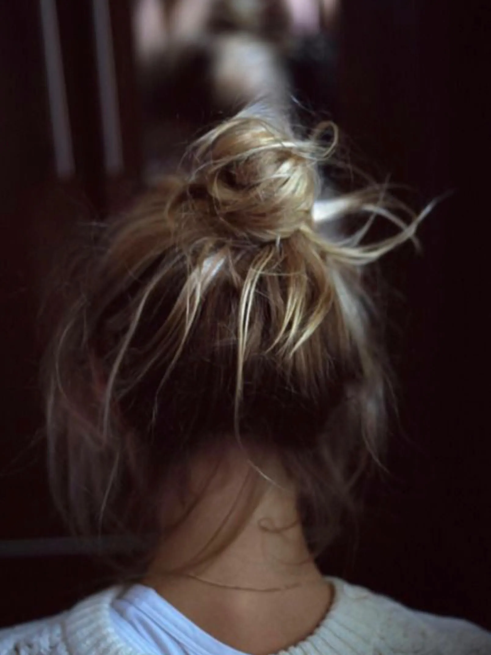 Messy high bun with loose strands