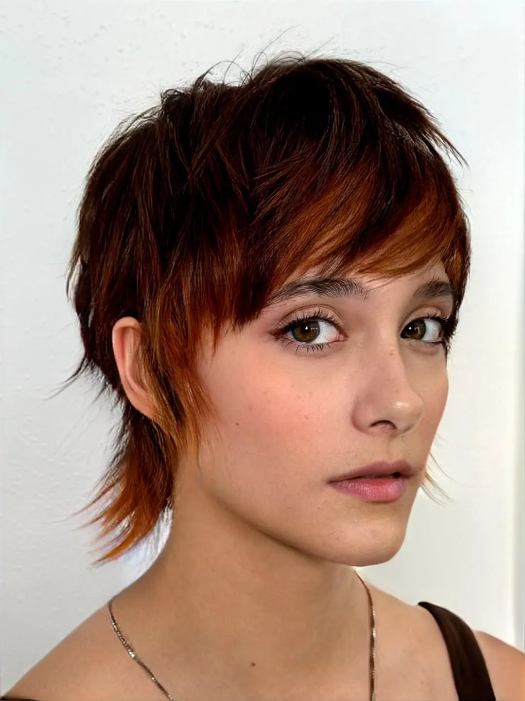 Layered auburn pixie mullet with side fringe