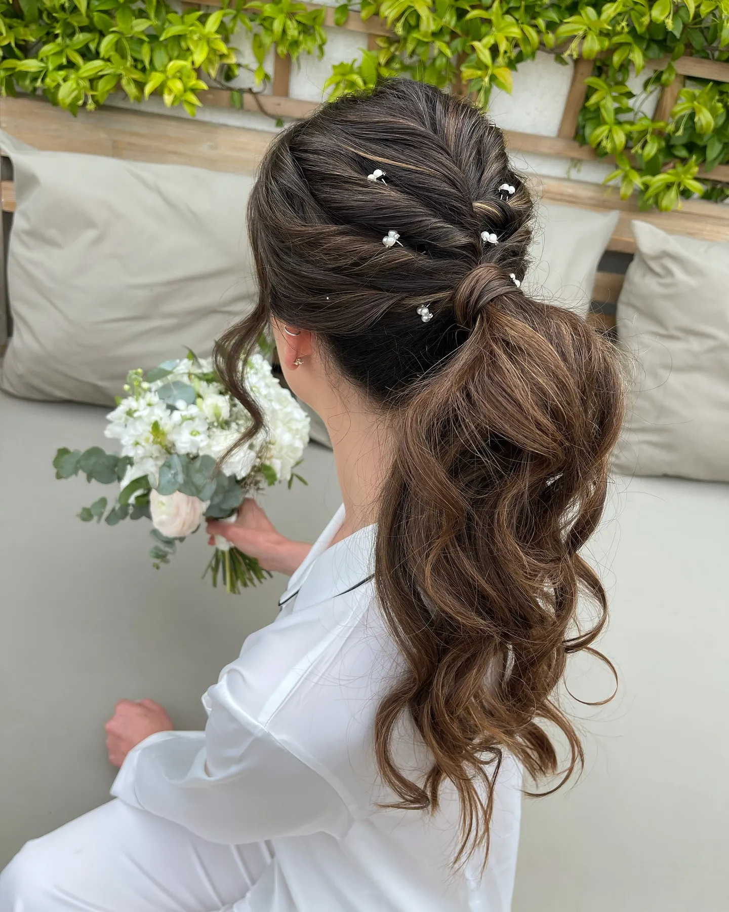 Textured bridal ponytail with twisted crown and pearl details