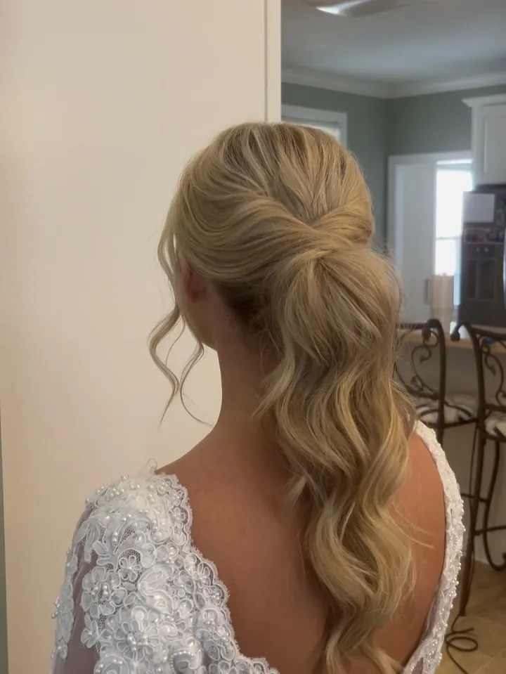 Blonde bridal ponytail with twisted crown and loose waves