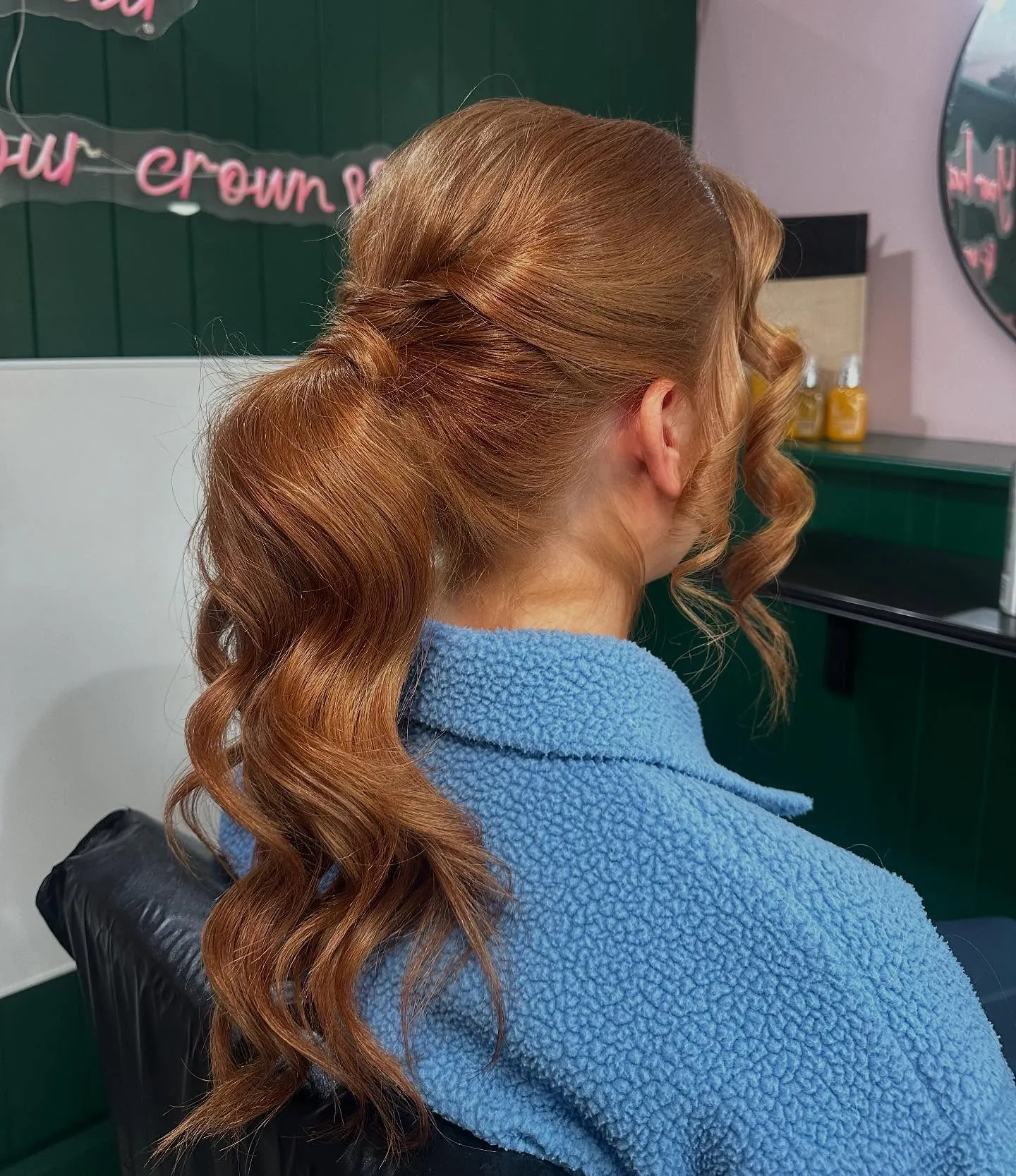 Voluminous copper ponytail with soft curls