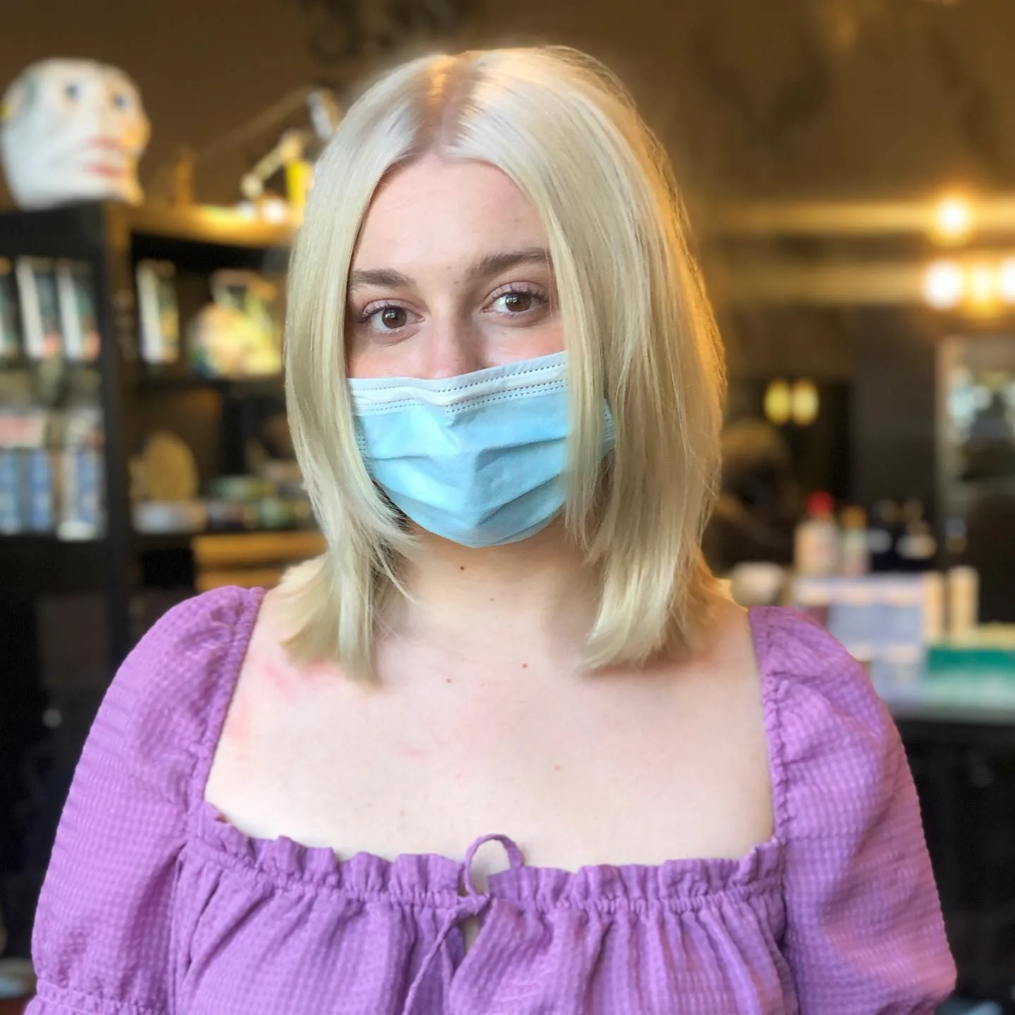 Sleek baby blonde bob with centre part
